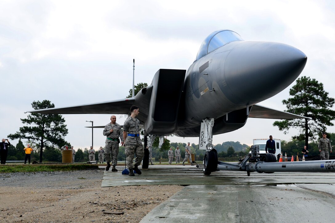 U.S. Air Force 1st Maintenance Group and 633rd Civil Engineer Squadron personnel bring an F-15 Eagle off the flight line to put on static display at Langley Air Force Base, Va., Oct. 4, 2014. The Airmen set up the plane near the West Gate entrance to the base. (U.S. Air Force photo by Airman 1st Class Devin Scott Michaels/Released)