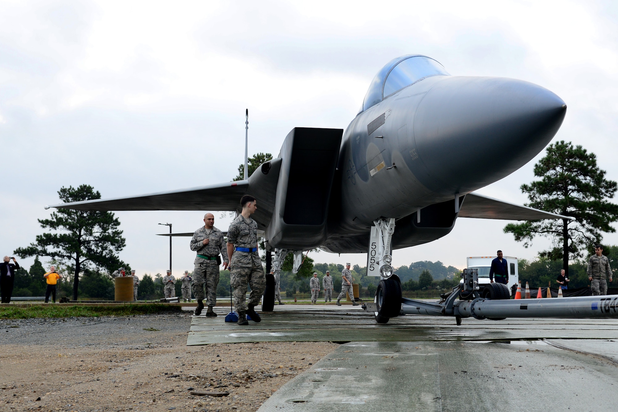 U.S. Air Force 1st Maintenance Group and 633rd Civil Engineer Squadron personnel bring an F-15 Eagle off the flight line to put on static display at Langley Air Force Base, Va., Oct. 4, 2014. The Airmen set up the plane near the West Gate entrance to the base. (U.S. Air Force photo by Airman 1st Class Devin Scott Michaels/Released)