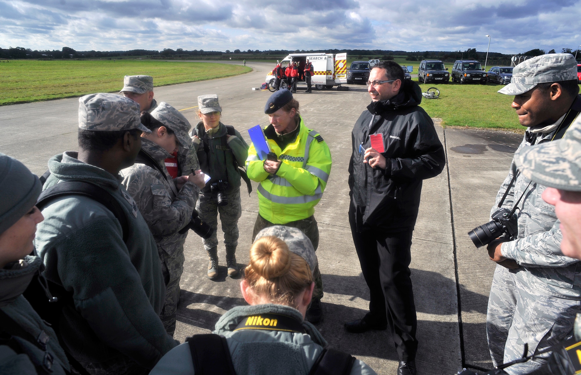 Airmen from the 100th Air Refueling Wing Public Affairs office interact with simulated media during a Major Accident Response Exercise Oct. 7, 2014, on RAF Honington. During this scenario, public affairs instructed first responders on how to work with media. (U.S. Air Force photo/Senior Airman Christine Griffiths/Released)