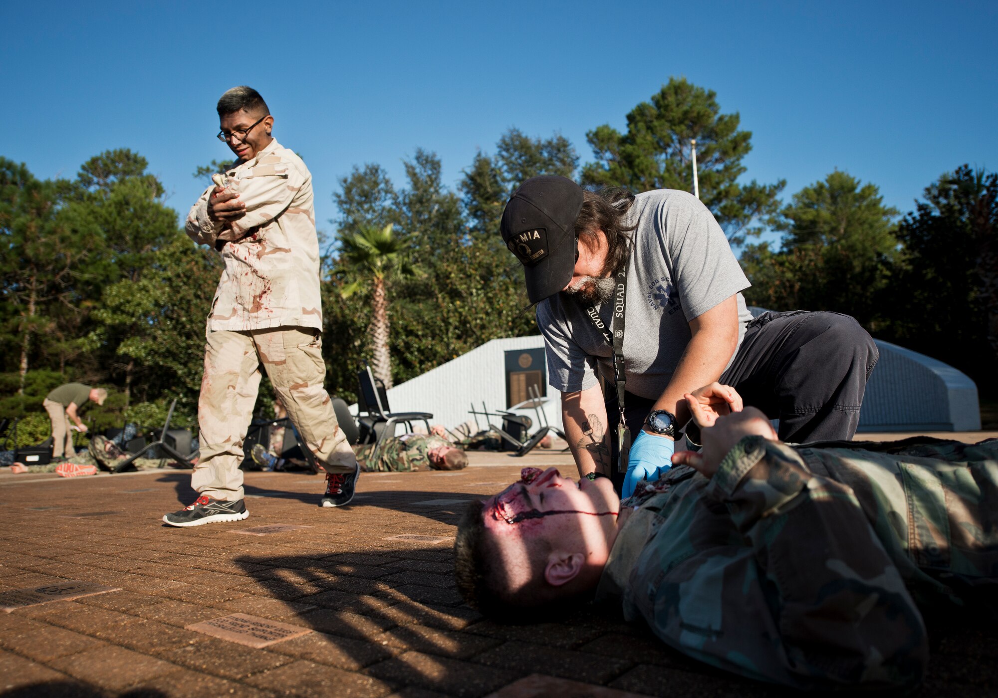 Navy School Explosive Ordnance Disposal medics evaluate simulated victims during a major accident response exercise Oct. 7 at Eglin Air Force Base, Fla.  The exercise scenario was a simulated vehicle-borne improvised explosive device was detonated at the EOD school house killing and injuring students. The exercise helped train Navy EOD School staff, Team Eglin first responders and local emergency crews.  Firefighters and emergency medical technicians responded to the scene to put out the fire and assist the victims.  (U.S. Air Force photo/Samuel King Jr.)
