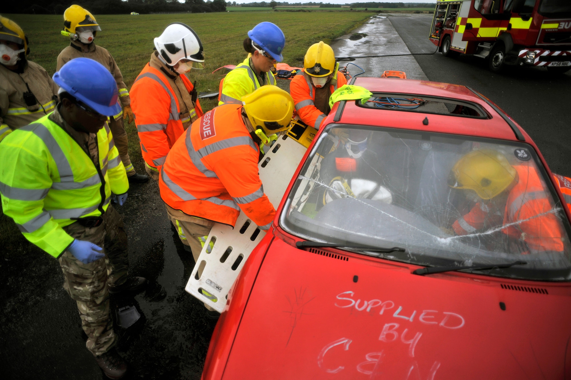 First responders from RAF Honington and Suffolk Fire and Rescue Service simulate extracting an injured patient from a car during a Major Accident Response Exercise Oct. 7, 2014, on RAF Honington, England. The purpose of the MARE was to test the response actions of RAF Mildenhall, RAF Honington and local first responders.  (U.S. Air Force photo/Senior Airman Christine Griffiths/Released)