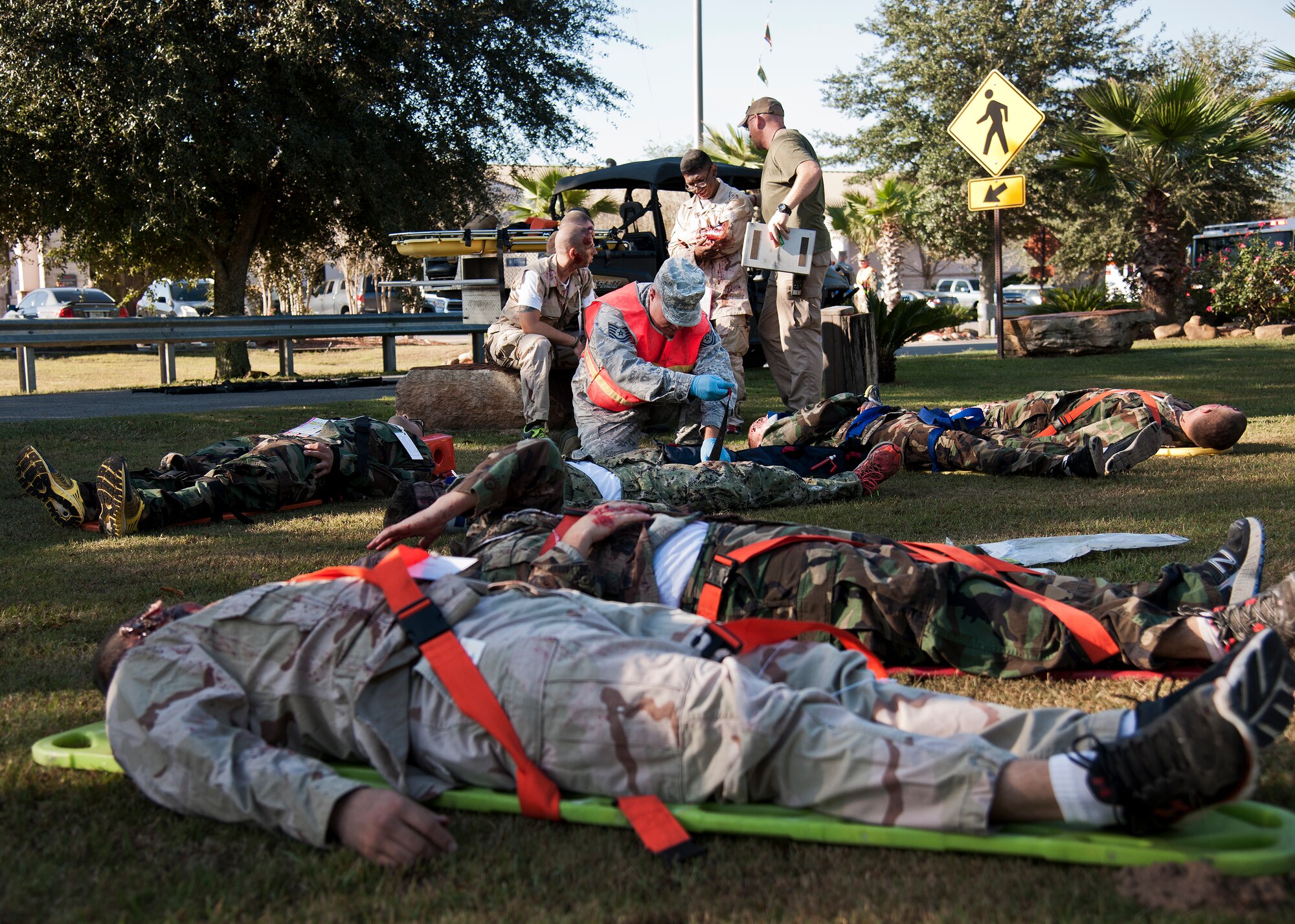 Navy School Explosive Ordnance Disposal and Team Eglin medics evaluate the simulated injured victims in the staging area during a major accident response exercise Oct. 7 at Eglin Air Force Base, Fla.  The exercise scenario was a simulated vehicle-borne improvised explosive device was detonated at the EOD school house killing and injuring students. The exercise helped train Navy EOD School staff, Team Eglin first responders and local emergency crews.  Firefighters and emergency medical technicians responded to the scene to put out the fire and assist the victims.  (U.S. Air Force photo/Samuel King Jr.)