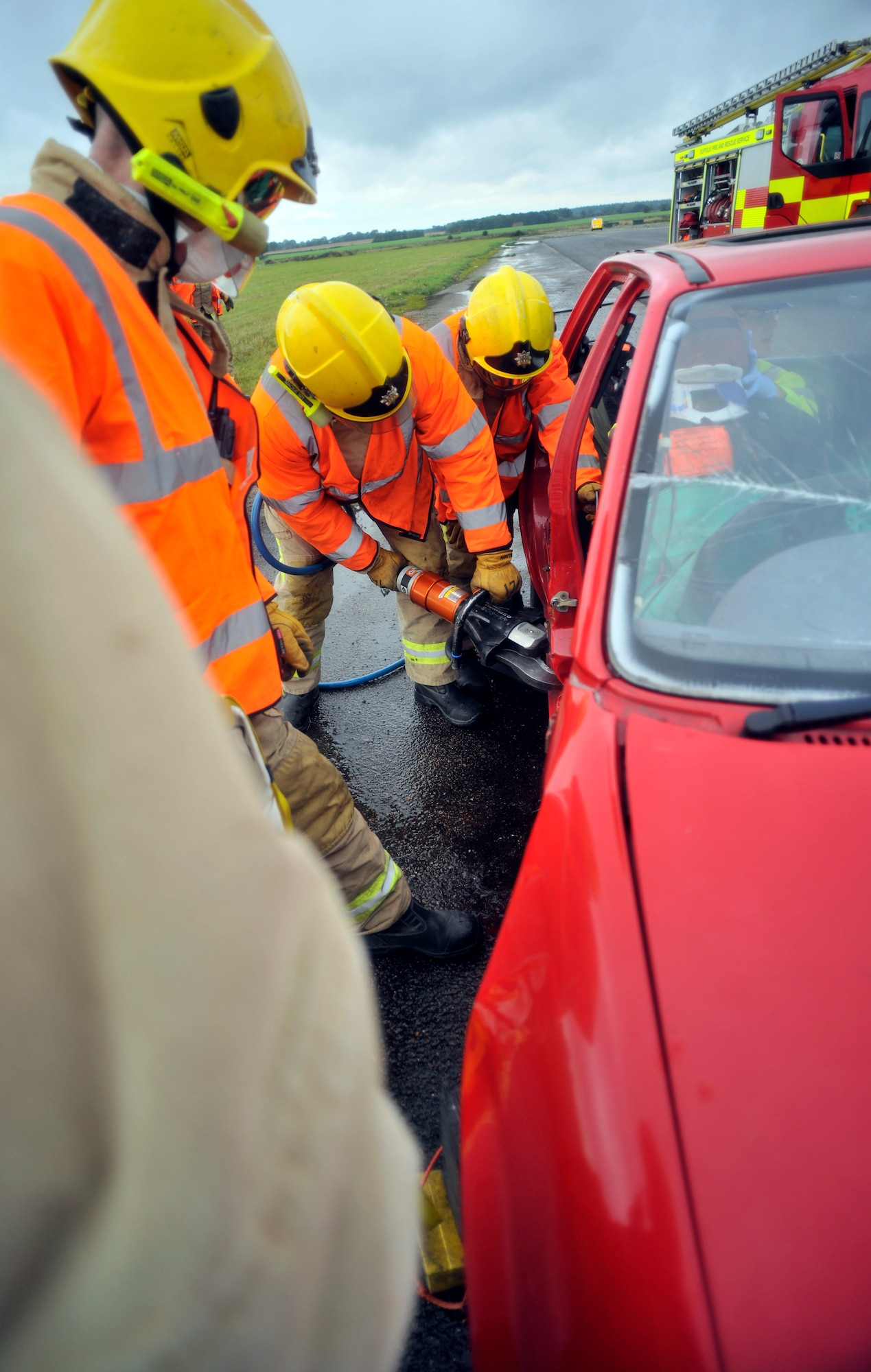 First responders from Suffolk Fire and Rescue Service use the Jaws of Life to simulate extracting an injured patient from a car during a Major Accident Response Exercise Oct. 7, 2014, on RAF Honington, England. The purpose of the MARE was to test the response actions of RAF Mildenhall, RAF Honington and local first responders.  (U.S. Air Force photo/Senior Airman Christine Griffiths/Released)