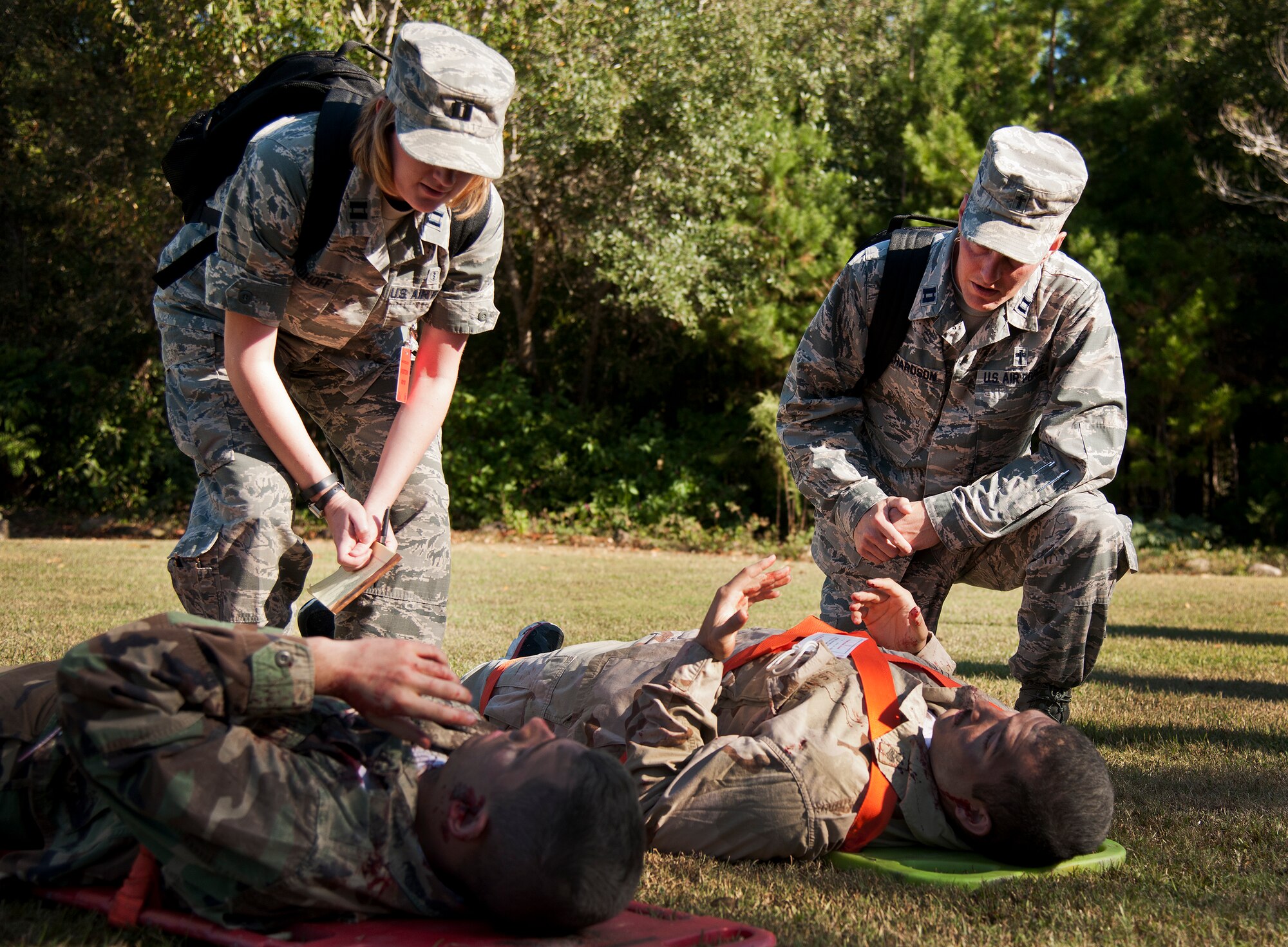 Captains Lesley Friedhoff and John Richardson, from the 96th Test Wing mental health office and chapel respectively, speak with the simulated victims about their experience during a major accident response exercise Oct. 7 at Eglin Air Force Base, Fla.  The exercise scenario was a simulated vehicle-borne improvised explosive device was detonated at the EOD school house killing and injuring students. The exercise helped train Navy EOD School staff, Team Eglin first responders and local emergency crews.  Firefighters and emergency medical technicians responded to the scene to put out the fire and assist the victims.  (U.S. Air Force photo/Samuel King Jr.)