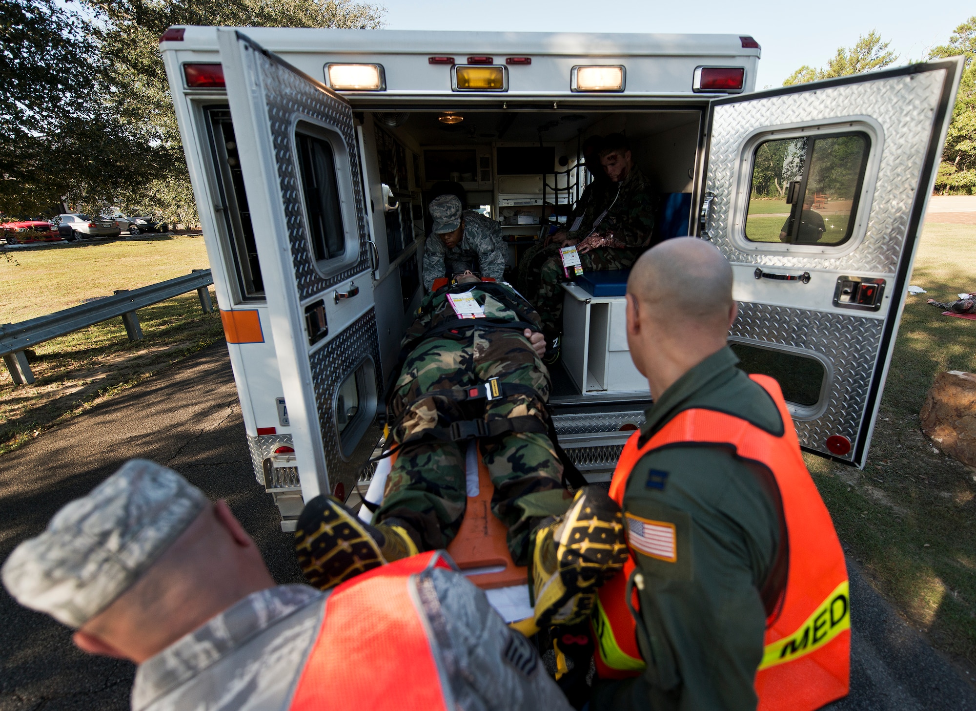 Team Eglin medics load a simulated priority victim into the ambulance during  a major accident response exercise Oct. 7 at Eglin Air Force Base, Fla.  The exercise scenario was a simulated vehicle-borne improvised explosive device was detonated at the explosive ordnance disposal school house killing and injuring students. The exercise helped train Navy EOD School staff, Team Eglin first responders and local emergency crews.  Firefighters and emergency medical technicians responded to the scene to put out the fire and assist the victims.  (U.S. Air Force photo/Samuel King Jr.)