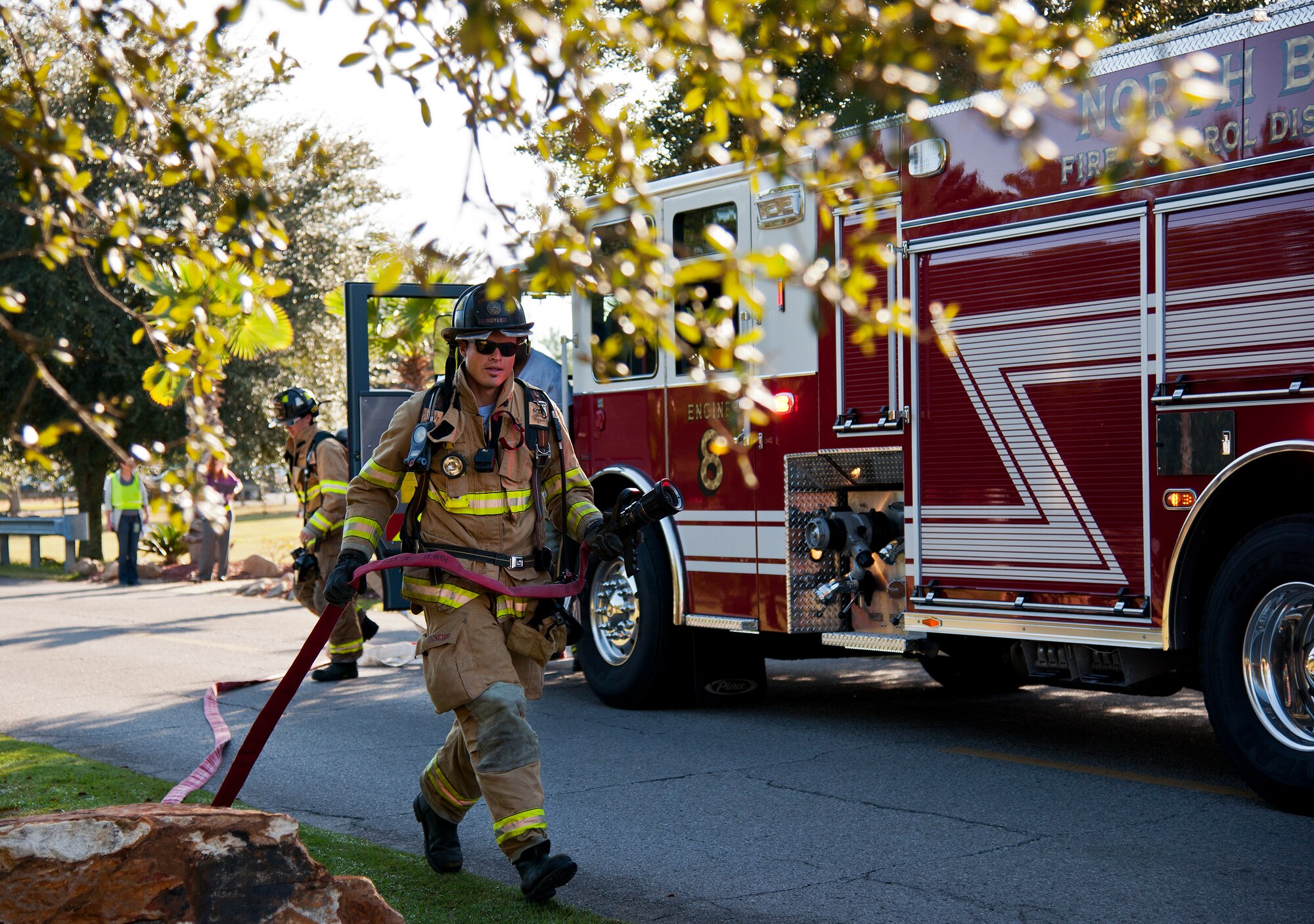 A North Bay firefighter moves in toward the accident scene during a major accident response exercise Oct. 7 at Eglin Air Force Base, Fla.  The exercise scenario was a simulated vehicle-borne improvised explosive device was detonated at the explosive ordnance disposal school house killing and injuring students. The exercise helped train Navy EOD School staff, Team Eglin first responders and local emergency crews.  Firefighters and emergency medical technicians responded to the scene to put out the fire and assist the victims.  (U.S. Air Force photo/Samuel King Jr.)