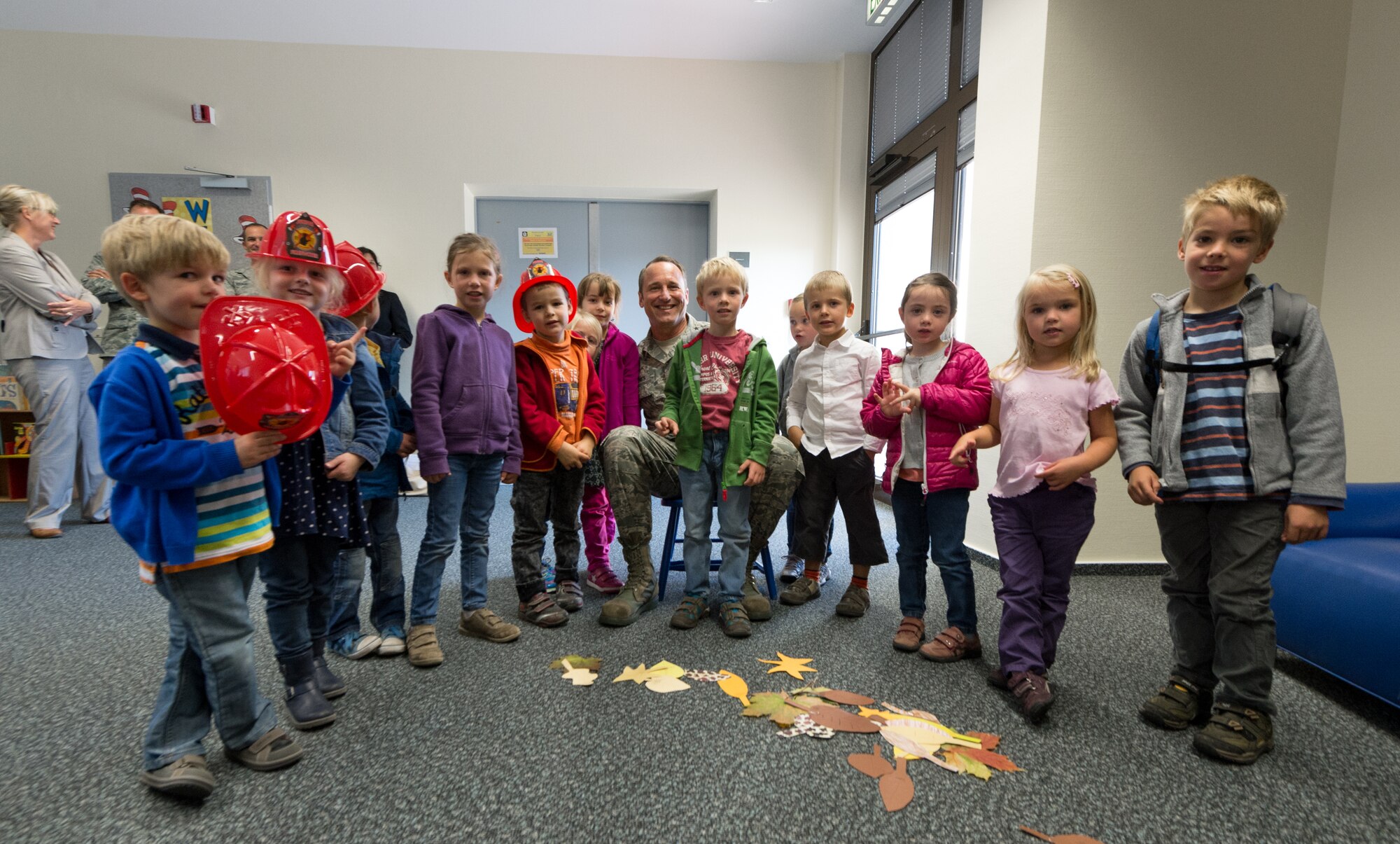 Lt. Gen. Noel Jones, U.S. Air Forces in Europe vice commander, takes a photo with a group of children from the Villa Winzig Kindergarten during a tour of Ramstein Air Base, Germany, Oct. 2, 2014. With more than 50,000 American citizens living in the greater Kaiserslautern area, U.S. Air Force units have shared a 60-year partnership with their host nation counterparts and since 2009 several groups of German kindergarten children have visited Ramstein to continue those relationships. (U.S. Air Force photo/Airman 1st Class Jordan Castelan)