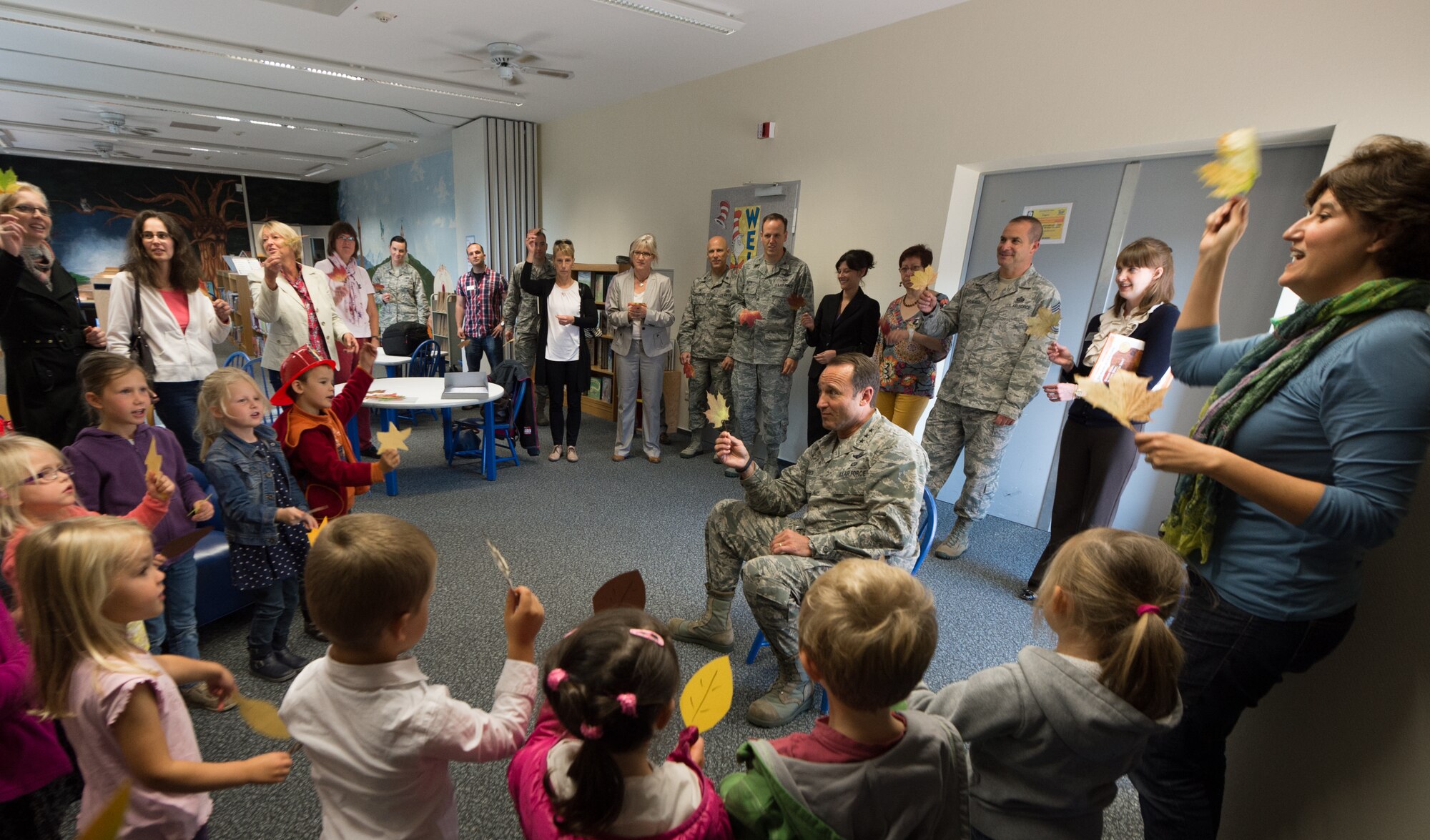 Lt. Gen. Noel Jones, U.S. Air Forces in Europe vice commander, joins a group of children from the Villa Winzig Kindergarten in singing during a tour of Ramstein Air Base, Germany, Oct. 2, 2014. With more than 50,000 American citizens living in the greater Kaiserslautern area, U.S. Air Force units have shared a 60-year partnership with their host nation counterparts and since 2009 several groups of German kindergarten children have visited Ramstein to continue those relationships. (U.S. Air Force photo/Airman 1st Class Jordan Castelan)