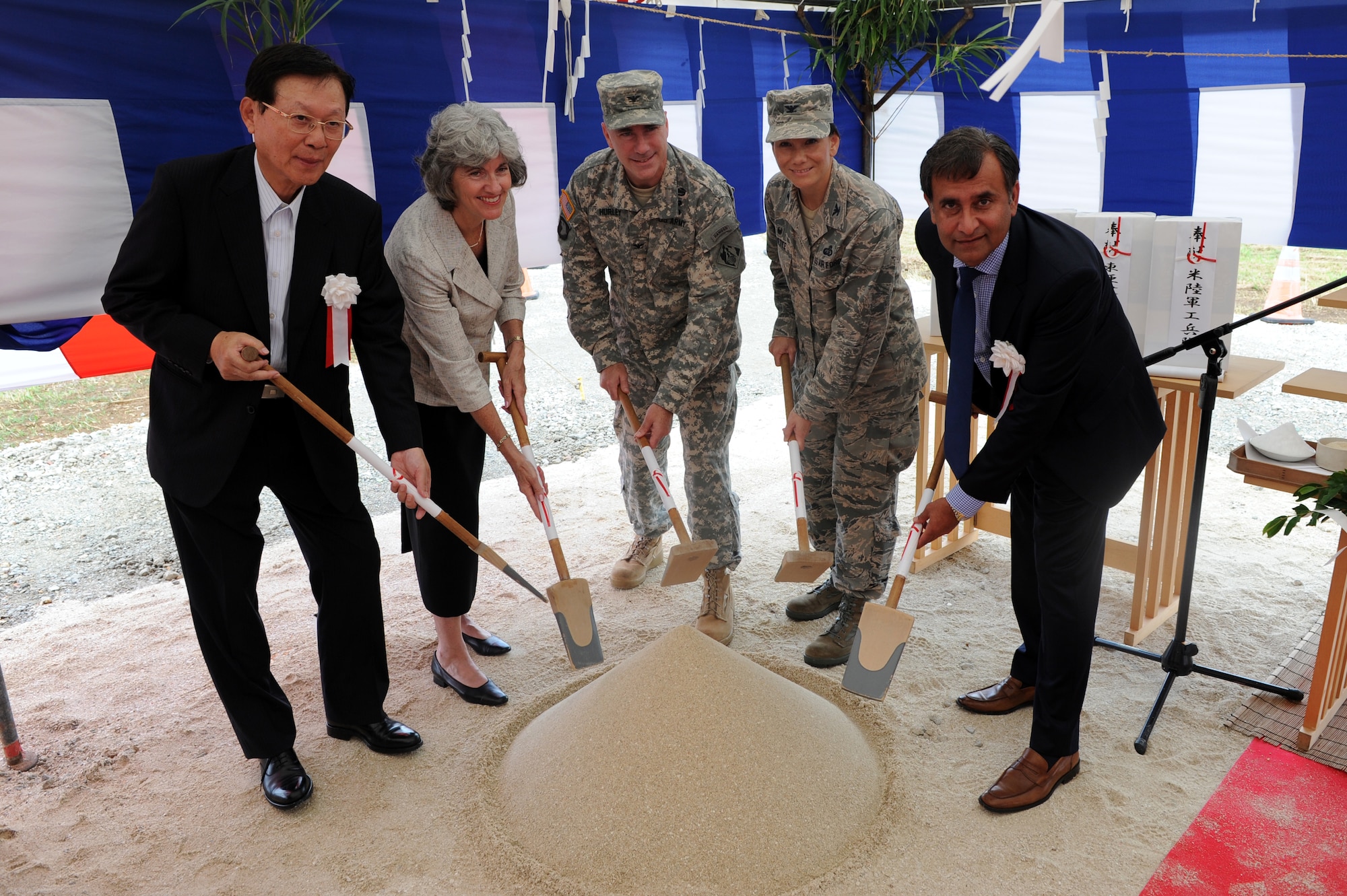 From left to right, Masaomi Matsuo, TOA Corporation president and chief executive officer; Linda Curtis, Department of Defense Education Activities Pacific Area Office director; U.S. Army Col. John Hurley, U.S. Army Corps of Engineers Japan District commander; U.S. Air Force Col. Deborah Lovette, 18th Mission Support Group commander; and Sarabjit Singh Narula, Gilbane Federal president, broke ground on the new school on Kadena Air Base, Japan, Oct. 2, 2014. The  school is scheduled to be completed by 2017, and will accommodate more than 800 students. (U.S. Air Force photo by Airman 1st Class Stephen G. Eigel) 