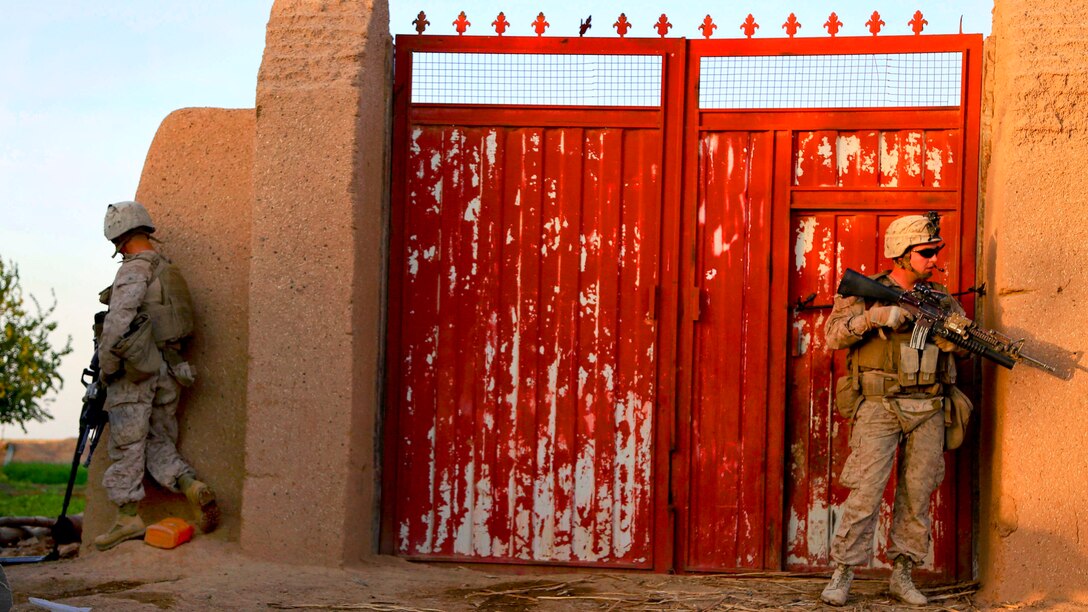U.S. Marine Corps Lance Cpls. Dalton Bentley, left, and Daniel Keeler provide security inside a compound during a patrol in Nad Ali district in Helmand province, Afghanistan, Oct. 7, 2014. Bentley, an automatic rifleman, and Keeler, a team leader, are assigned to 3d Platoon, Bravo Company, 1st Battalion, 2d Marine Regiment.