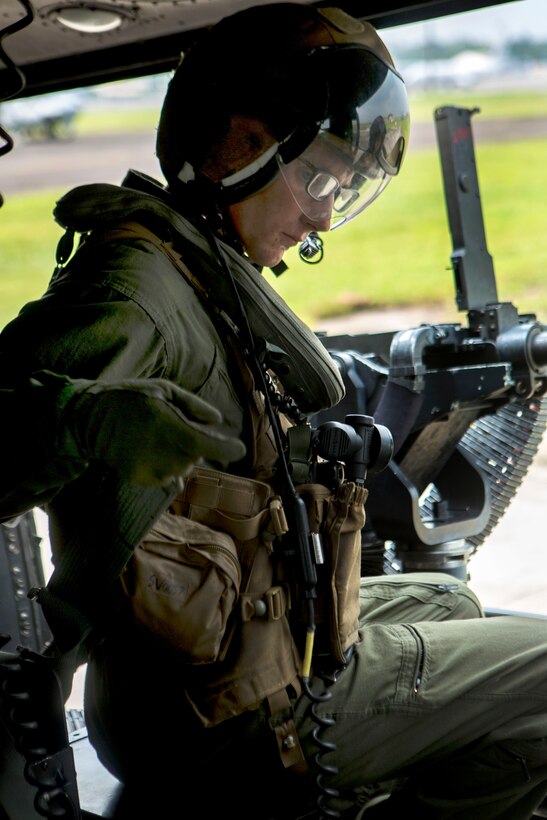 U.S. Marine Corps Lance Cpl. Travis Paul prepares for takeoff inside a UH-1Y Venom helicopter during Amphibious Landing Exercise, PHIBLEX 15, on Clark Air Base, Palawan, Philippines, Oct. 4, 2014. Paul is a crew chief assigned to Medium Tiltrotor Squadron 262 Reinforced, 31st Marine Expeditionary Unit.