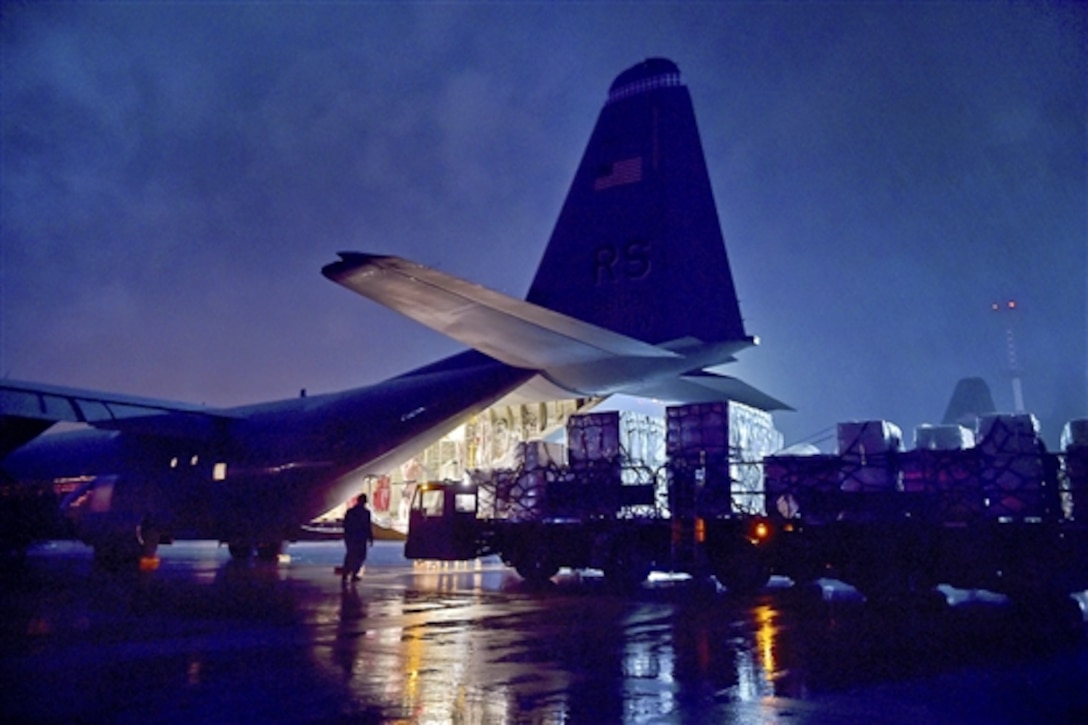 U.S. airmen load cargo onto the ramp of a C-130-J Super Hercules aircraft on Ramstein Air Base, Germany, Oct. 7, 2014, to prepare for a mission to help contain the Ebola outbreak in Liberia. U.S. Africa Command is supporting the U.S. Agency for International Development as part of Operation United Assistance, a comprehensive U.S. government effort to contain the outbreak.