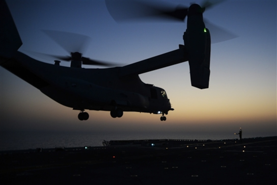 A U.S. seaman signals an MV-22B Osprey aircraft launching from the flight deck aboard the amphibious assault ship USS Makin Island in the Arabian Gulf, Oct. 5, 2014. The Makin Island Amphibious Ready Group and the embarked 11th Marine Expeditionary Unit are deployed in support of maritime security operations and theater security cooperation efforts in the U.S. 5th Fleet area of responsibility. 
