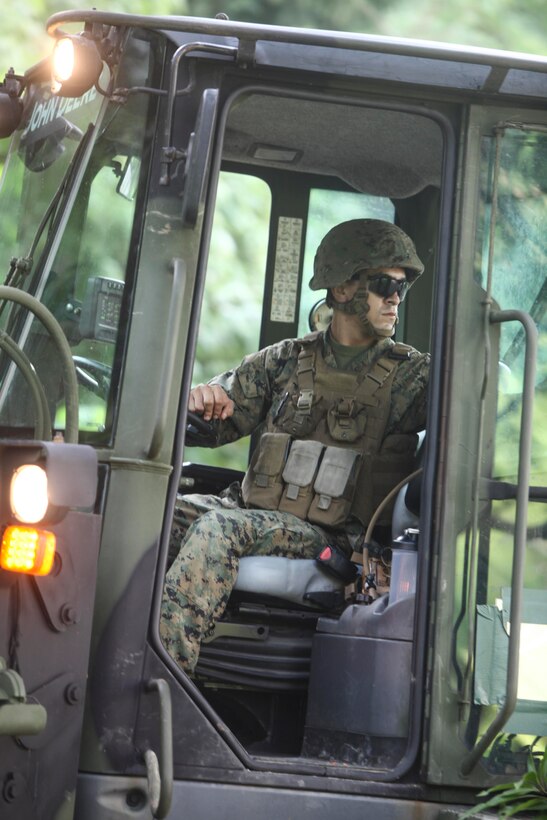 U.S. Marine Lance Corporal Octavio Ramirez maneuvers a tractor rubber-tire articulate-steering multipurpose vehicle, or TRAM, after moving a large boulder during Amphibious Landing Exercise 15 at Marine Corps Base Gregorio Lim in Ternate, the Philippines, Oct. 7. PHIBLEX is an annual, bilateral training exercise conducted by members of the Armed Forces of the Philippines alongside U.S Marine and Navy forces focused on strengthening the partnership and relationships between the two nations across a range of military operations including disaster relief and complex expeditionary operations. Ramirez is the section noncommissioned officer of heavy equipment with Combat Logistics Battalion 31, 31st Marine Expeditionary Unit, and a native of Atlanta.