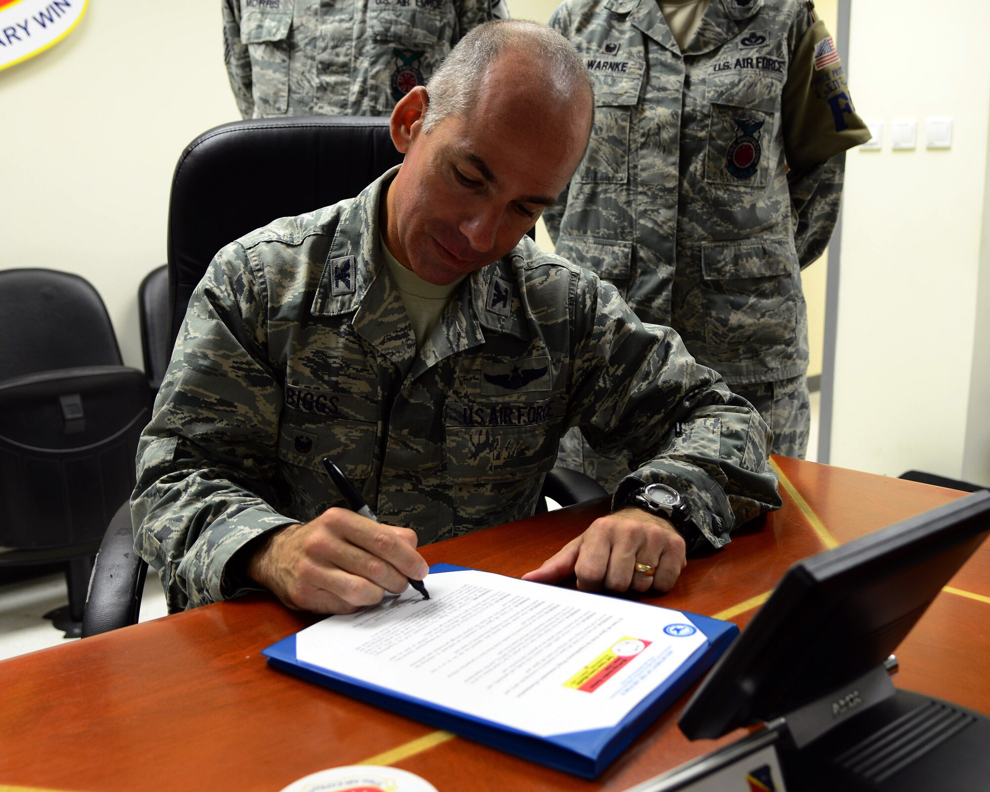 U.S. Air Force Col. Steve Biggs, 379th Air Expeditionary Wing vice commander, signs a fire proclamation for Fire Prevention Week at Al Udeid Air Base, Qatar, Oct. 6, 2014. Fire Prevention Week is a nationwide event, to educate people on fire prevention and safety. (U.S. Air Force photo by Staff Sgt. Ciara Wymbs) 