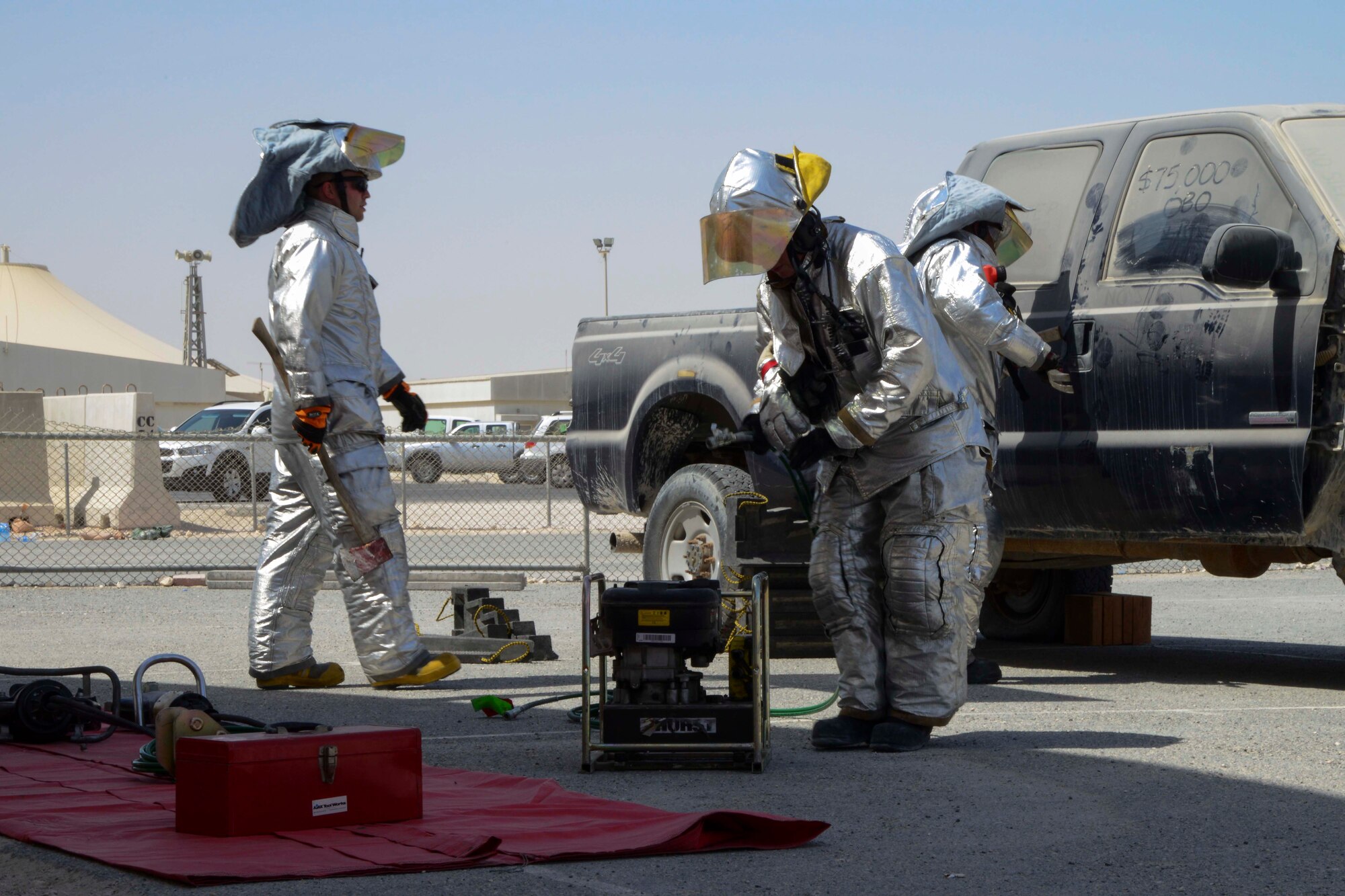 U.S. Air Force Airmen assigned to the 379th Expeditionary Civil Engineer Squadron prepare for a vehicle extrication demonstration at Al Udeid Air Base, Qatar, Oct. 8, 2014. Vehicle extrication is the process of removing a vehicle from around a person who has been involved in a motor vehicle accident. (U.S. Air Force photo by Staff Sgt. Ciara Wymbs) 
