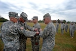 Army Maj. Gen. Judd H. Lyons, right, acting director of the Army National Guard, joins Army Col. Jayson Spade, left, commander of the 1st Information Operations Command (Land) and Army Lt. Gen. Edward Cardon, commander of Army Cyber Command and Second Army, in placing the Cyber Command shoulder sleeve insignia on the uniform of Army Maj. Hung Diep, commander of the 1636th Cyber Protection Team in a patch ceremony at Fort George G. Meade, Maryland, Tuesday Oct. 7, 2014. The 1636th CPT is the first Army National Guard cyber protection team to be activated and is one of 10 cyber protection teams planned throughout the Army Guard. 