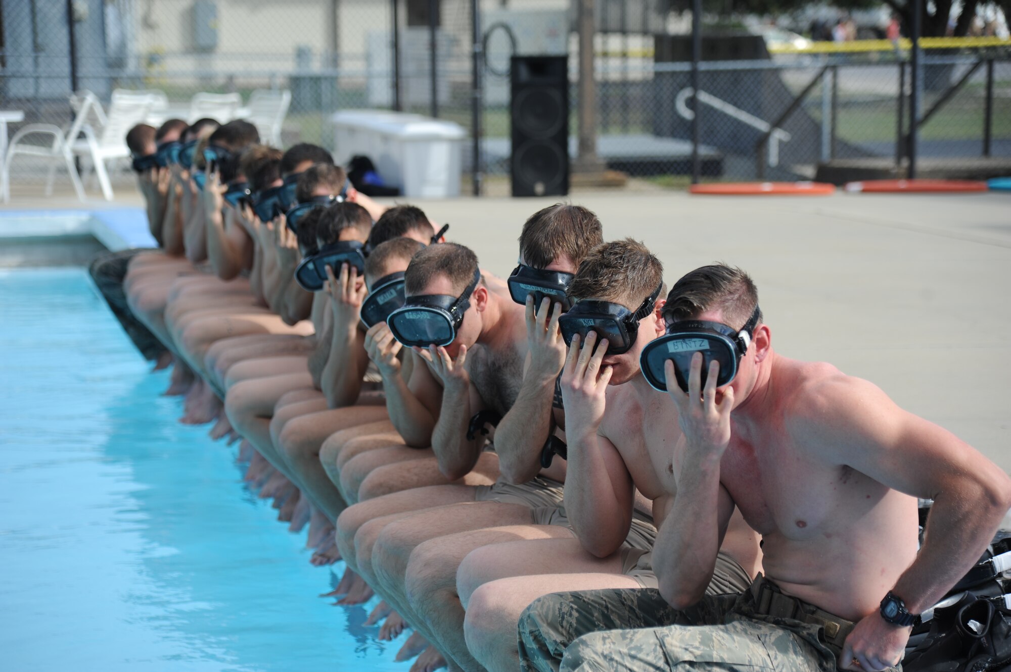 Members of the 334th Training Squadron combat controllers and the 335th Training Squadron special operations weather team prepare to enter the triangle pool as they participate in a memorial physical training session Sept. 26, 2014, at Keesler Air Force Base, Miss. The session included a ruck march along the Ocean Springs Beach and over the Biloxi-Ocean Springs Bridge. The PT event was in memory of combat controllers Senior Airman Mark Forester, who was killed in action Sept. 29, 2010, and Senior Airman Daniel Sanchez, who was KIA Sept. 16, 2010. (U.S. Air Force photo/Kemberly Groue)