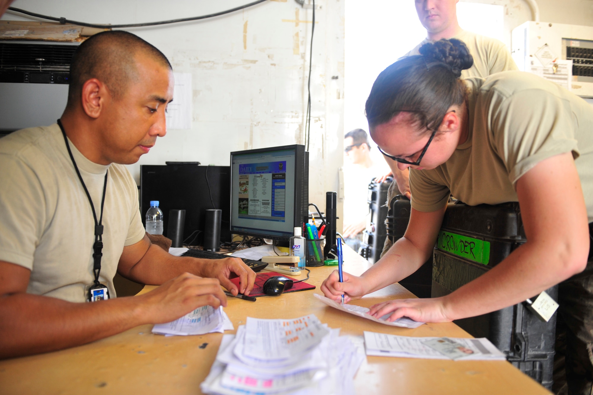 U.S. Air Force Tech. Sgt. Rodney Ignacio, 379th Expeditionary Logistics Readiness Squadron armory noncommissioned officer in-charge, issues Service members their weapons Al Udeid Air Base, Qatar, Oct. 7, 2014. The armory will process more than 7,000 weapons over a month and a half time period. (U.S. Air Force photo by Senior Airman Colin Cates)   
