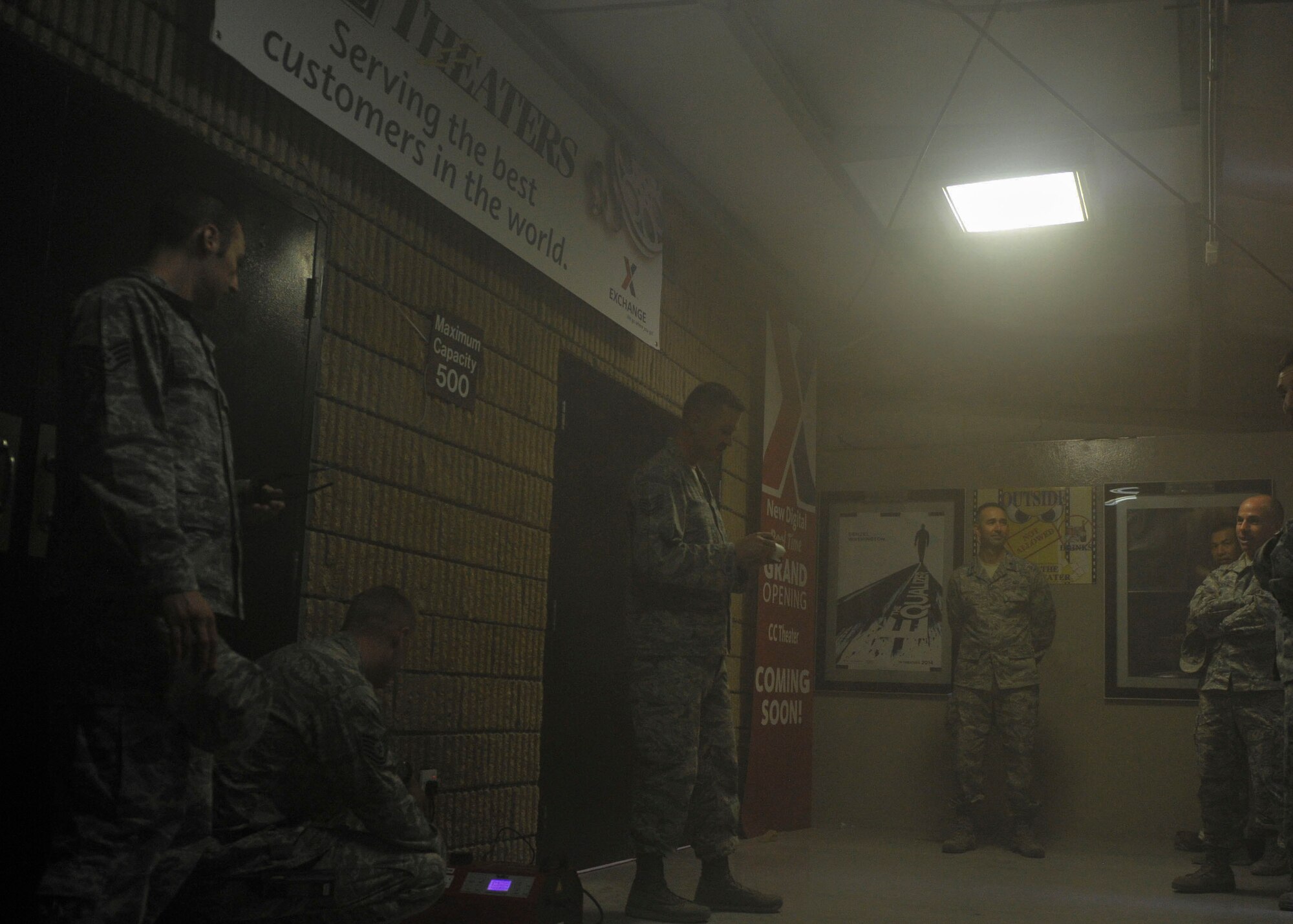 Members from the Al Udeid Air Force Base Fire Department demonstrate the use of a smoke detector during Fire Prevention Week at Al Udeid Air Base, Qatar, Oct. 9, 2014. According to the National Fire Protection Association website, the week commemorates the Great Chicago Fire of 1871. The fire killed more than 250 people, left 100,000 homeless, destroyed more than 17,400 structures, and burned more than 2,000 acres. (U.S. Air Force photo by Senior Airman Colin Cates)