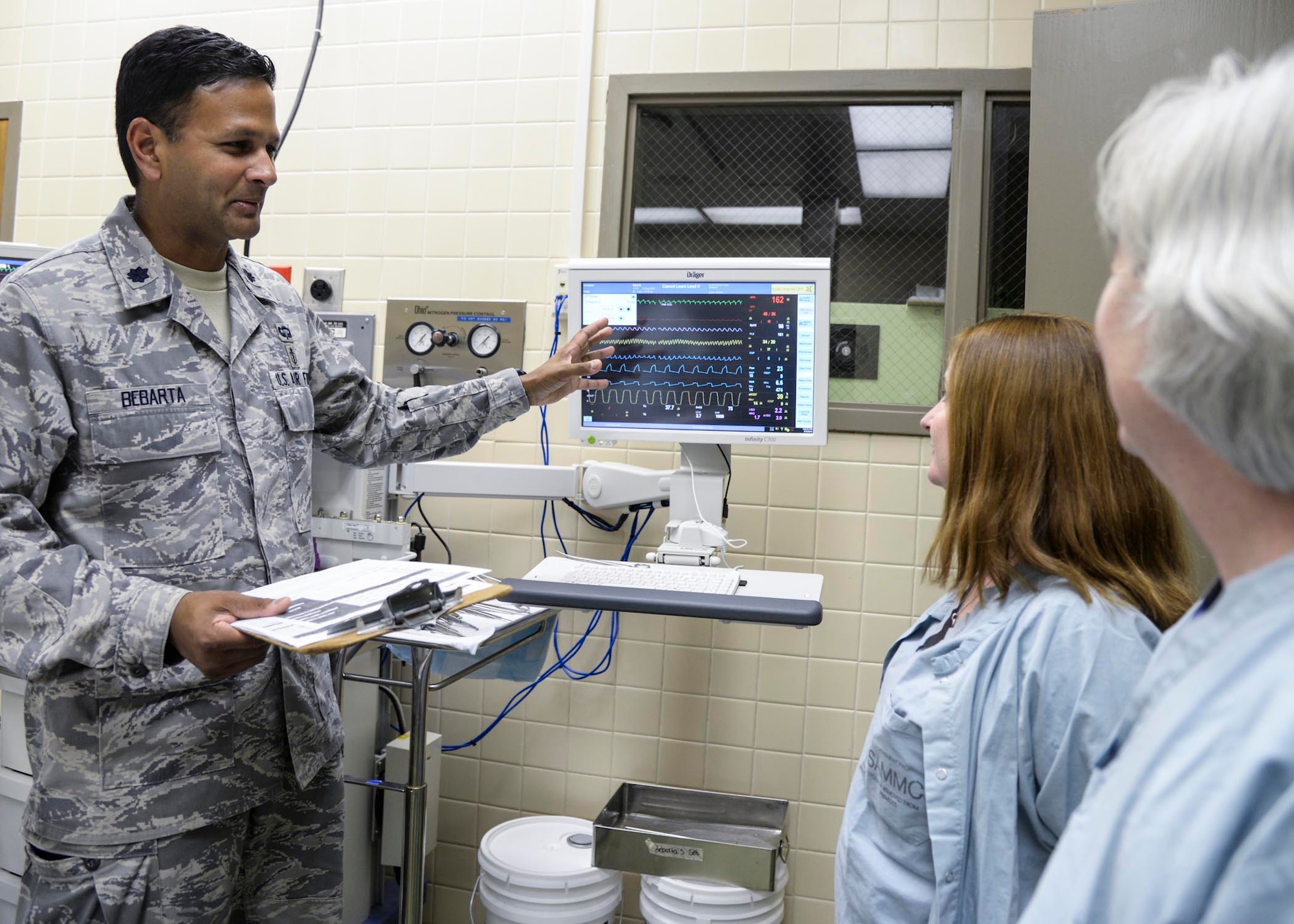 Lt. Col. Vikhyat Bebarta reviews statistics with fellow research technicians Aug. 12, 2014, at the Wilford Hall Ambulatory Surgical Center on Joint Base San Antonio-Lackland, Texas. Bebarta garnered the 2014 Paul W. Myers award and the National Society for Academic Emergency Medicine Basic Science award. Bebarta is the director of the 59th Medical Wing En Route Care Research Center (ECRC) and chief of medical toxicology at the San Antonio Military Medical Center on Joint Base San Antonio-Fort Sam Houston, Texas. (U.S. Air Force photo/Staff Sgt. Kevin Iinuma)