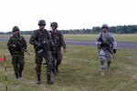 Canadian Army Maj. Edward Jun (left), commander, Company M, 3rd Battalion, Royal Canadian Regiment; Polish army Capt. Marcin Wilga (2nd from left), commander, 2nd Assault Company, 18th Airborne Battalion, 6th Airborne Brigade; and U.S. Army Capt. Matthew McCarthy (right), commander, Company D, 2nd Battalion, 503rd Infantry Regiment, 173rd Airborne Brigade, meet after commanding their units in a combined training exercise at Ziemsko Airfield, Poland, July 17. The exercise is part of Operation Atlantic Resolve and is intended to strengthen U.S. Army Europe’s (USAREUR) familiarity and commitment to its’ NATO allies.