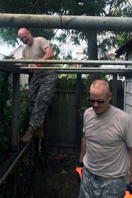 Lt. Col. Michael Sexton seeks to balance himself on a fence he intends to repair during a recent volunteer mission with the Omaha District. 