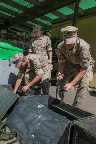 Recruits of Golf Company, 2nd Recruit Training Battalion, pick up their rifle cleaning kit and parade sling during their rifle issue aboard Marine Corps Recruit Depot San Diego, Sept. 29.  Over the course of recruit training, recruits will learn and understand the weapons safety and basic maintenance, and how to properly fire the weapon.