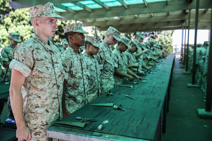 Recruits of Golf Company, 2nd Recruit Training Battalion, listen to directions while inspecting their rifle cleaning kits during rifle issue aboard Marine Corps Recruit Depot San Diego, Sept. 29.  Recruits and their rifles will become inseparable and function as one throughout the remainder of recruit training.