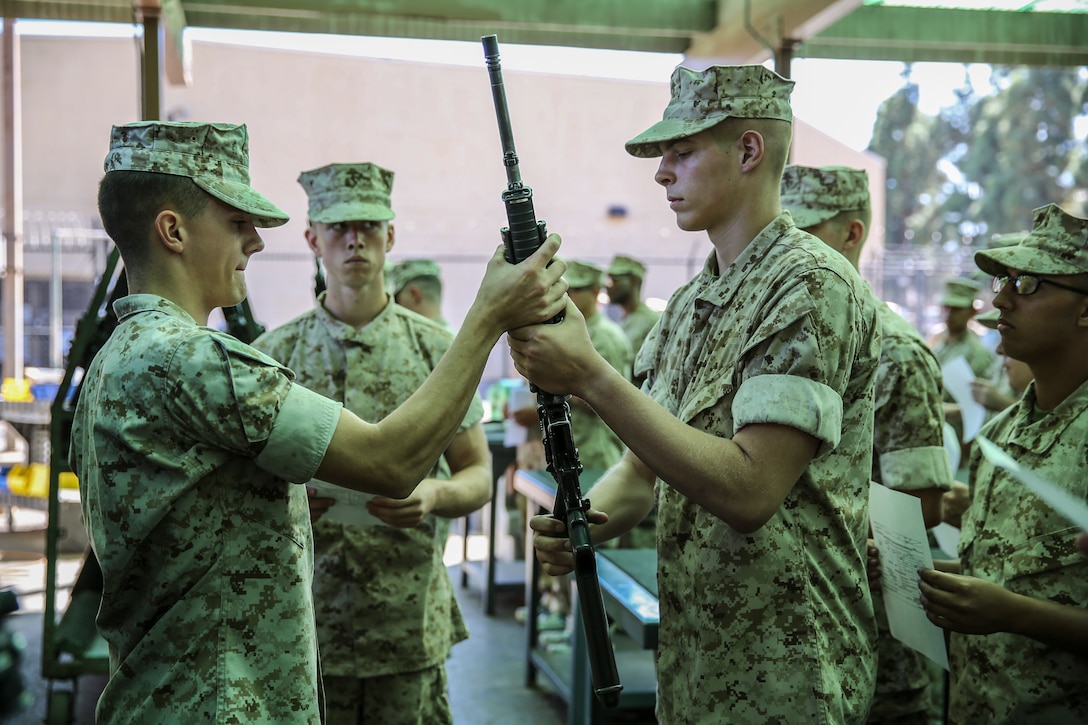 Cpl. Brendon M. Walsh, armorer, Headquarters Company, Headquarters and Service Battalion, hands an M16-A4 Service Rifle to Recruit Robert M. Gibson, Platoon 2154, Golf Company, 2nd Recruit Training Battalion, during rifle issue aboard Marine Corps Recruit Depot San Diego, Sept. 29.  Gibson is a Frazier Park, Calif., native and was recruited out of Recruiting Station Bakersfield, Calif.