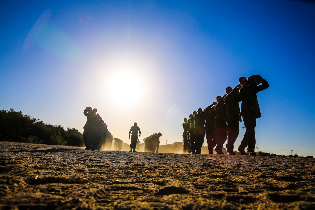 Recruits of Mike Company, 3rd Recruit Training Battalion, carry a log to the next exercise during the Log Drill event at Marine Corps Recruit Depot San Diego, Sept. 30. Each group of recruits worked through log exercises such as log push-ups, log squats and side benders. 