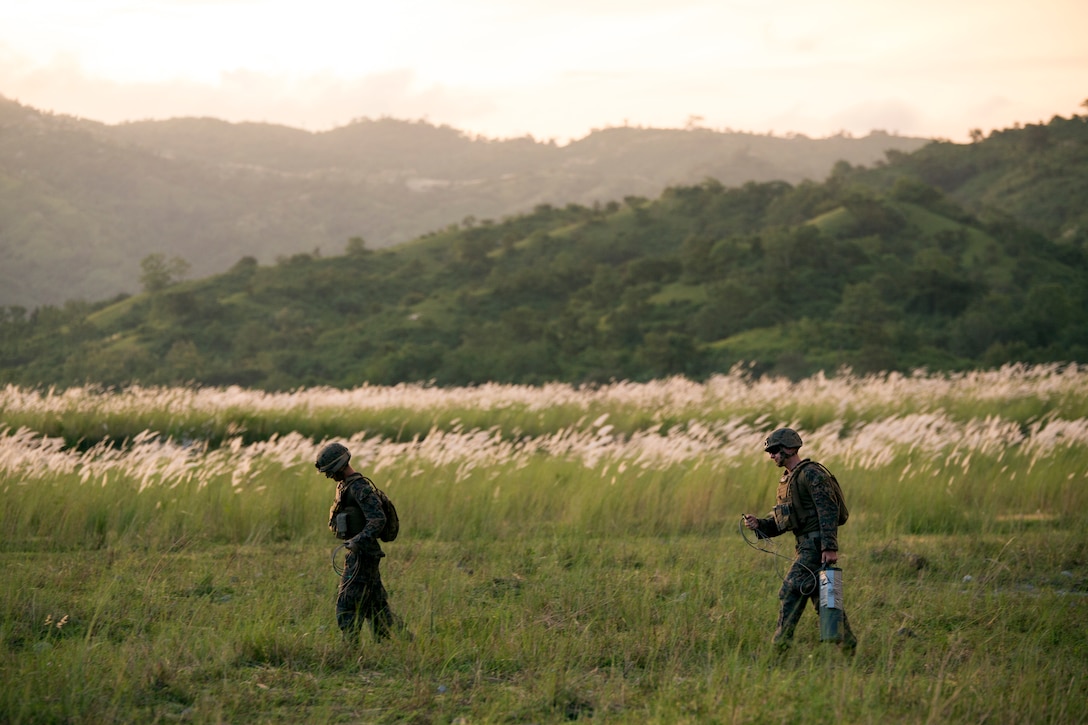 Two U.S. Marines walk toward a demolition pit with explosives at Crow Valley, the Philippines, during Amphibious Landing Exercise 15, Oct. 8. PHIBLEX is an annual, bilateral training exercise conducted by members of the Armed Forces of the Philippines alongside U.S. Marine and Navy forces focused on strengthening the partnership and relationships between the two nations across a range of military operations including disaster relief and complex expeditionary operations. The Marines are with Battalion Landing Team 3rd Battalion, 5th Marines, 31st Marine Expeditionary Unit. 