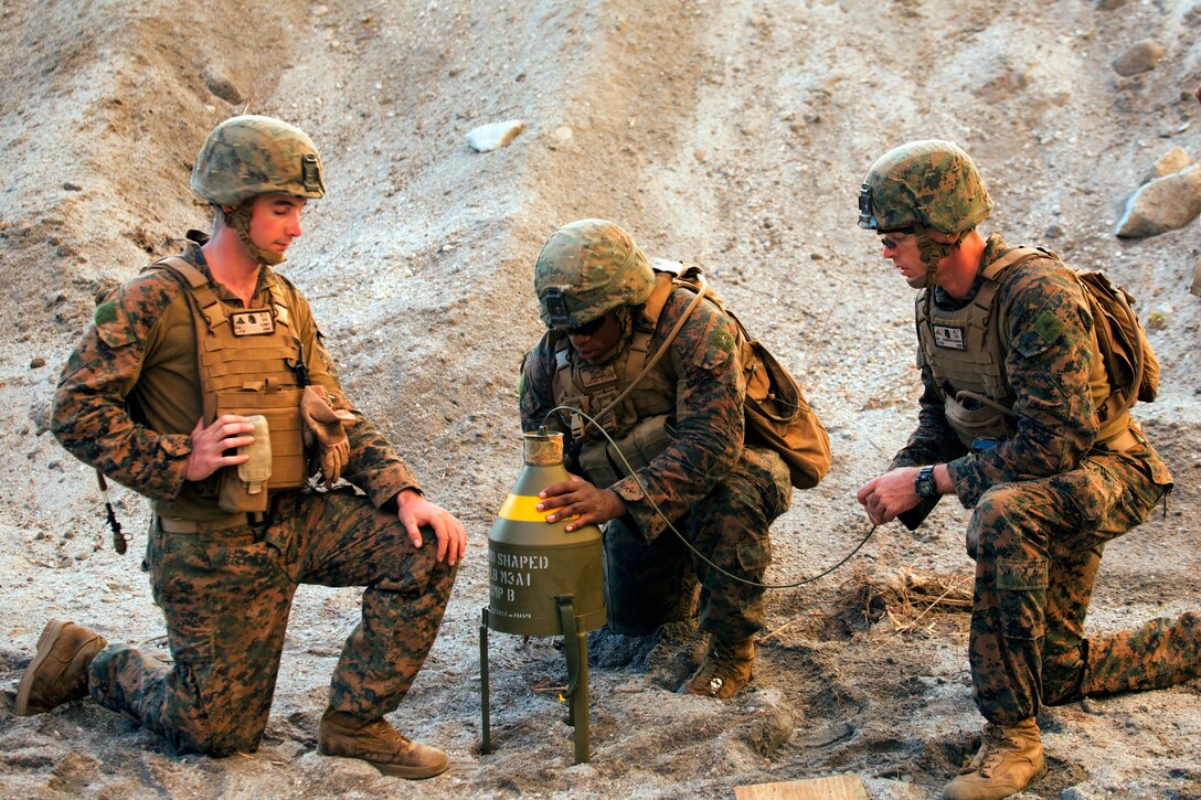 U.S. Marine Cpl. Malcom L. Crafton (middle) explains to Lance Cpl. Kent M. Curry (left) and Lance Cpl. Maxwell E. Ackerdeoliveira how to emplace the 40-pound M3A1 shaped charge at a demolitions range at Crow Valley, the Philippines, during Amphibious Landing Exercise 15, Oct. 8. PHIBLEX is an annual, bilateral training exercise conducted by members of the Armed Forces of the Philippines alongside U.S Marine and Navy forces focused on strengthening the partnership and relationships between the two nations across a range of military operations including disaster relief and complex expeditionary operations. The Marines are with Battalion Landing Team 3rd Battalion, 5th Marines, 31st Marine Expeditionary Unit. (U.S. Marine Corps Photo by Staff Sgt. Joseph DiGirolamo)