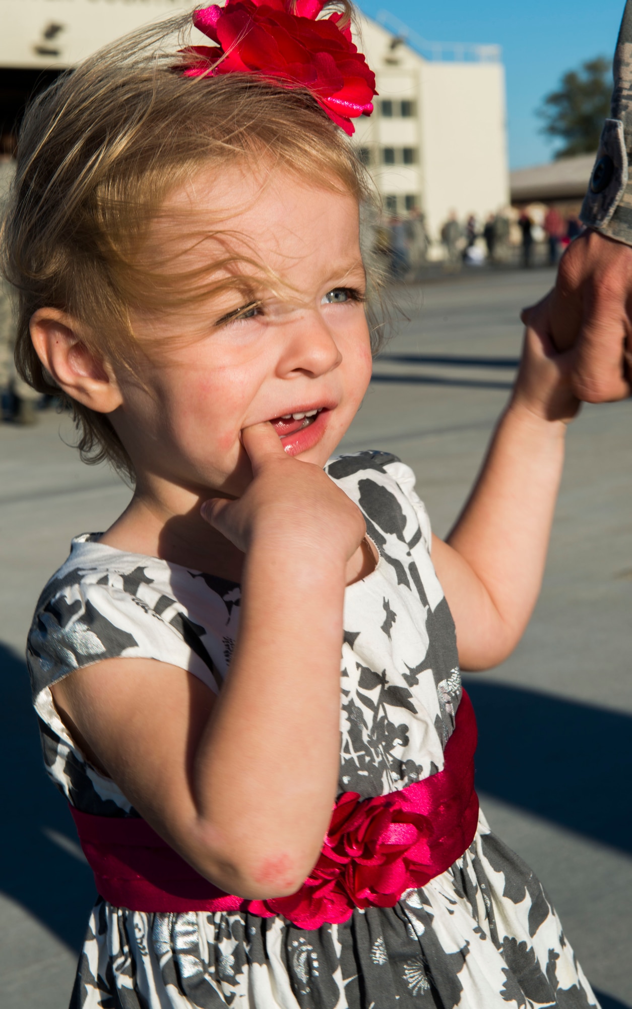 A little girl holds her dad’s hand after his homecoming Oct. 10, 2014, at Mountain Home Air Force Base, Idaho. The 391st Fighter Squadron flew with the Hawaiian Air National Guard increasing proficiency on fighter integration tactics between the F-22 and F-15E Strike Eagle. (U.S. Air Force photo by Airman 1st Class Malissa Lott/RELEASED)