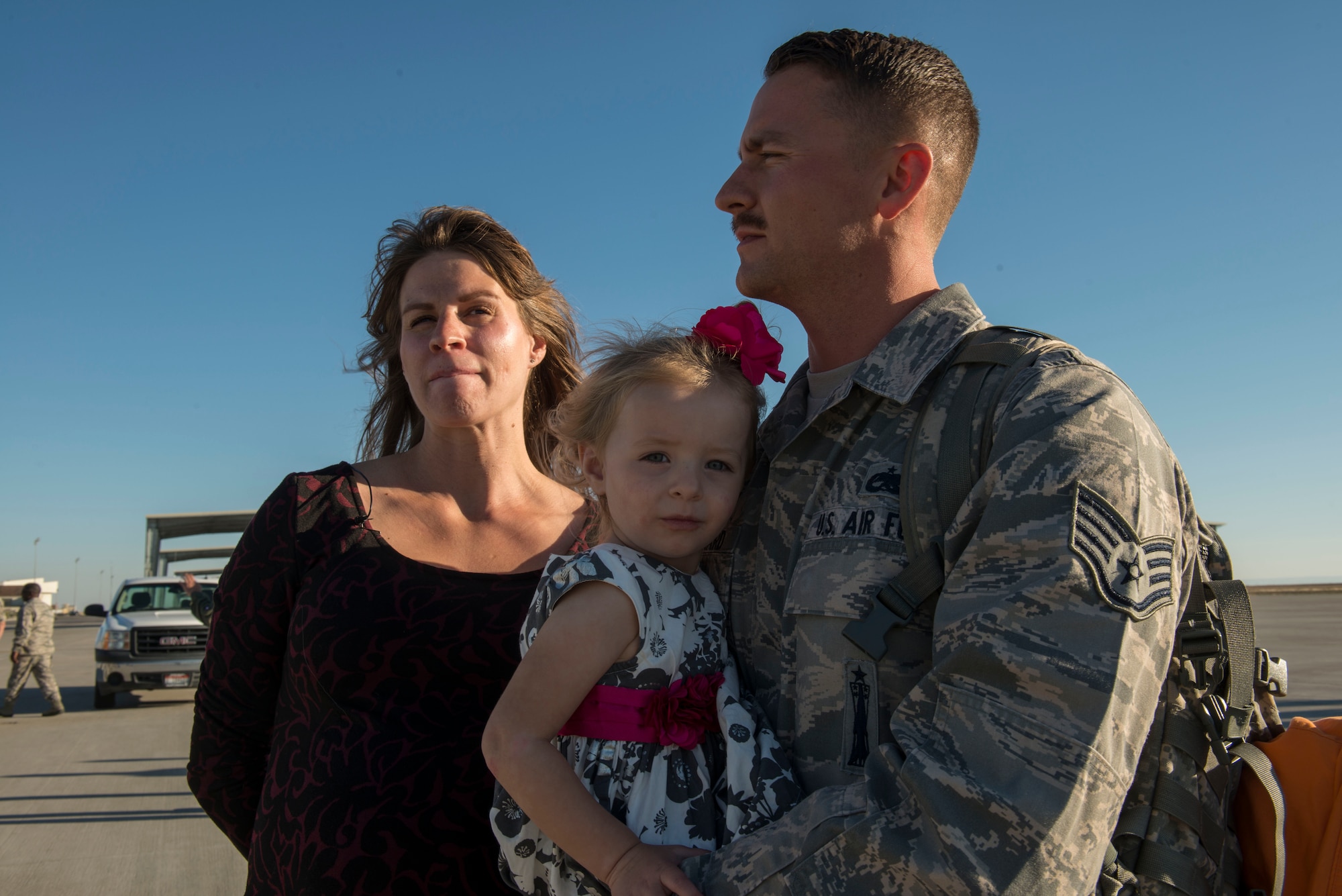 Staff Sgt. Ryan Pritchard, 391st Fighter Squadron weapons loader, stands with his wife and daughter after returning home Oct. 10, 2014, at Mountain Home Air Force Base, Idaho. Pritchard’s wife, who is pregnant, is thankful to have her husband home for the birth of their second child. (U.S. Air Force photo by Airman 1st Class Malissa Lott/RELEASED)