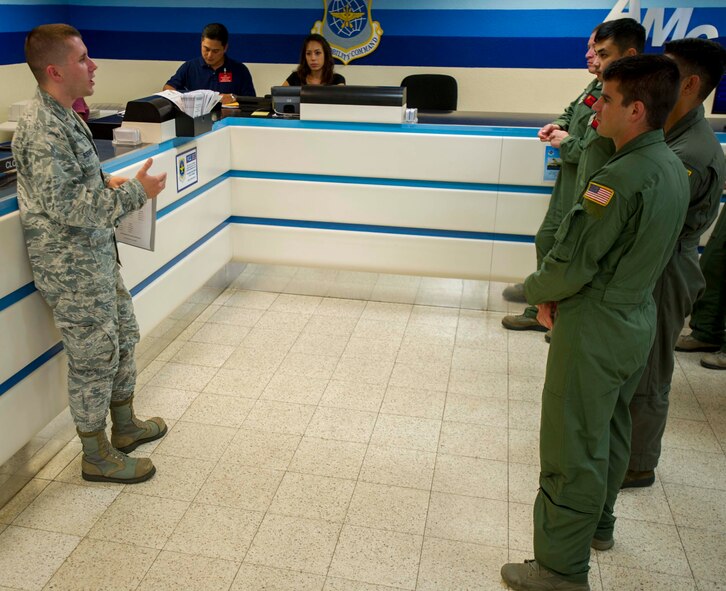 2nd Lt. Tyler Stevens, 735th Air Mobility Squadron Passenger and Fleet Service Flight officer in charge, explains how people are processed through passenger services at the Passenger Terminal during Operation Aircrew Orientation at Joint Base Pearl Harbor-Hickam, Hawaii, Oct. 9, 2014. Operation Aircrew offered members of the 535th Airlift Squadron a behind-the-scenes look at 735th AMS operations. During the tour, aircrew members were educated on the inner workings of an air mobility squadron including passenger services, air freight, Air Terminal Operations Center and Air Mobility Command Control Center. (U.S. Air Force photo by Tech. Sgt. Terri Paden)