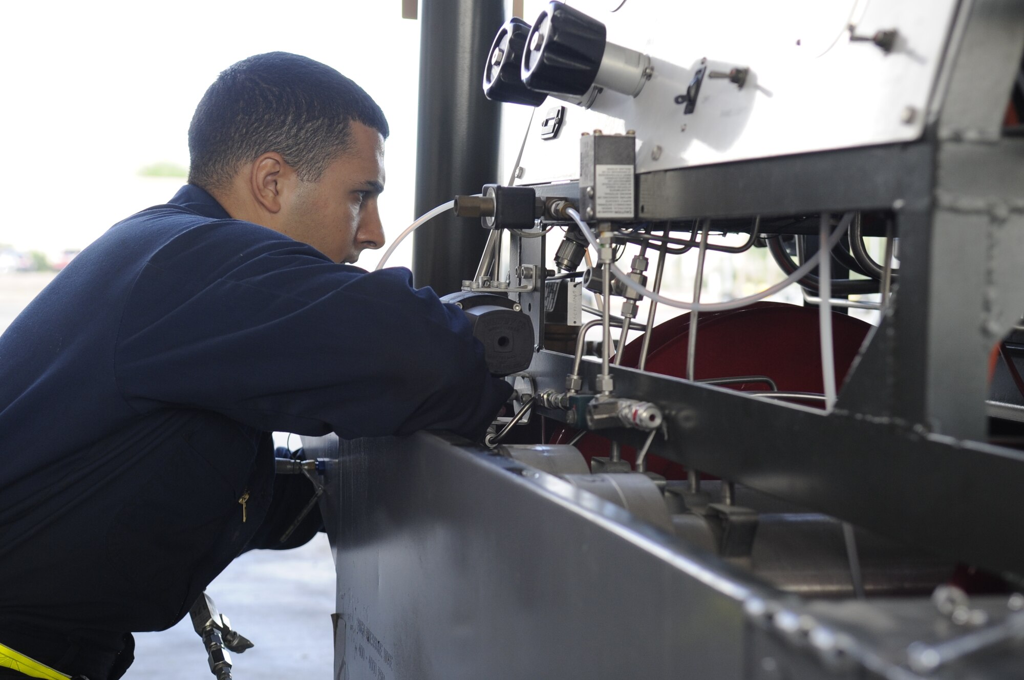 U.S. Air Force Airman 1st Class Jamal Miqbel, 355th Equipment Maintenance Squadron aerospace ground equipment journeyman, removes a panel from a self-generating nitrogen cart at Davis-Monthan Air Force Base, Ariz., Oct. 9, 2014. Miqbel removed the panel in order to replace a part that required a maintenance update. (U.S. Air Force photo by Airman 1st Class Betty R. Chevalier/Released)
