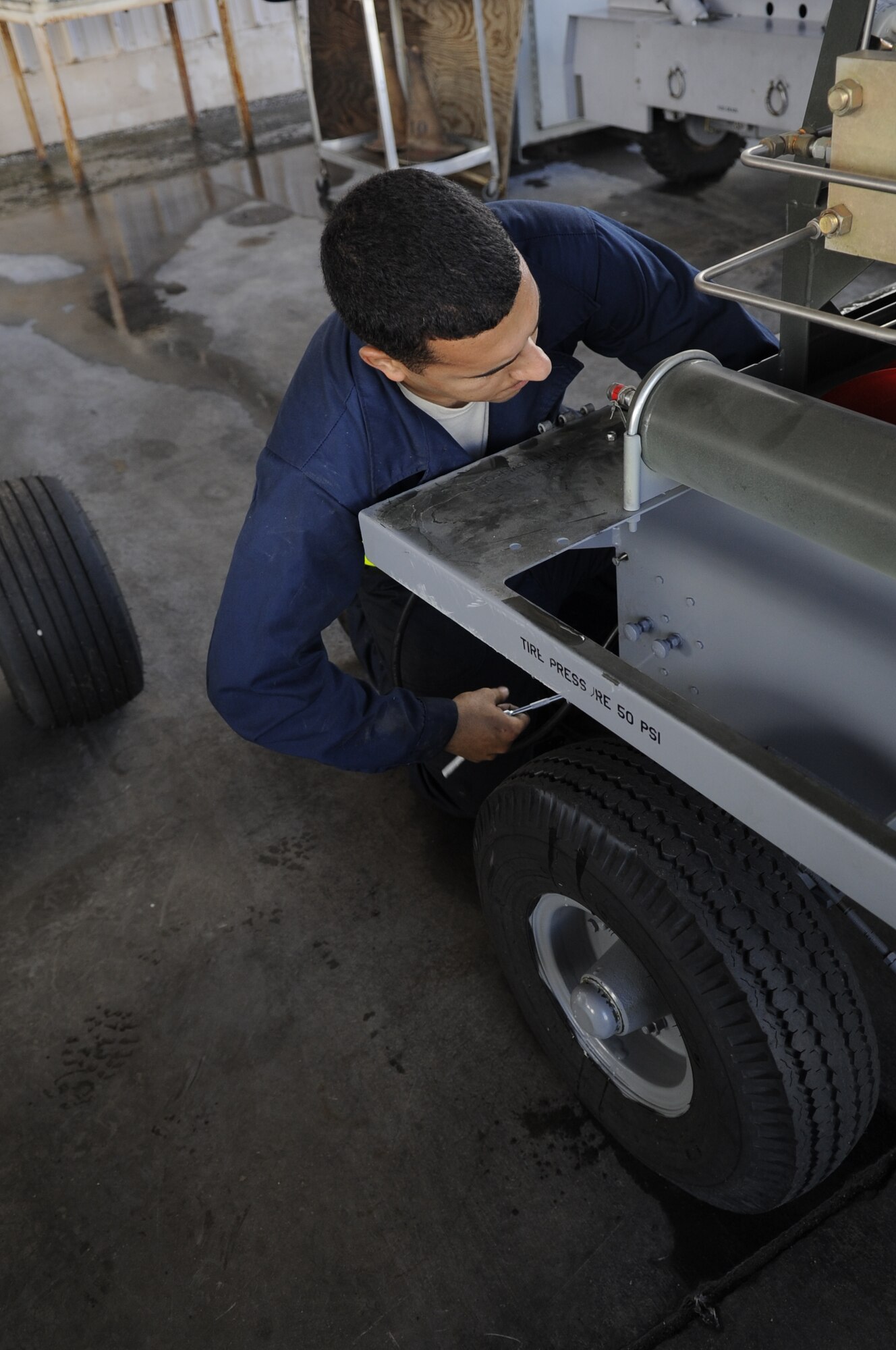 U.S. Air Force Airman 1st Class Jamal Miqbel, 355th Equipment Maintenance Squadron aerospace ground equipment journeyman, loosens a bolt on a self-generating nitrogen cart at Davis-Monthan Air Force Base, Ariz., Oct. 9, 2014 The cart allows Airmen to be more efficient by eliminating the use of nitrogen tanks. (U.S. Air Force photo by Airman 1st Class Betty R. Chevalier/Released)