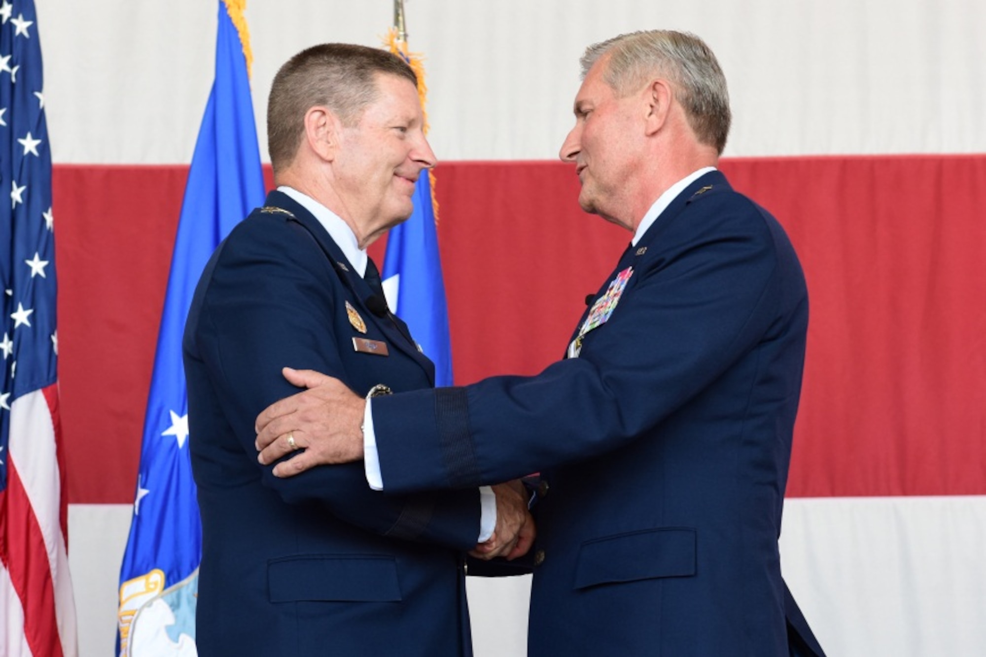 General Robin Rand, commander, Air Education and Training Command, congratulates Maj. Gen. Lance Undhjem, after presenting him with a retirement pin at Luke Air Force Base, Ariz. Oct. 10, 2014. Undhjem retired after 39 years of service in the United States Air Force. (U.S. Air Force photo by Staff Sgt. Lausanne Kinder)