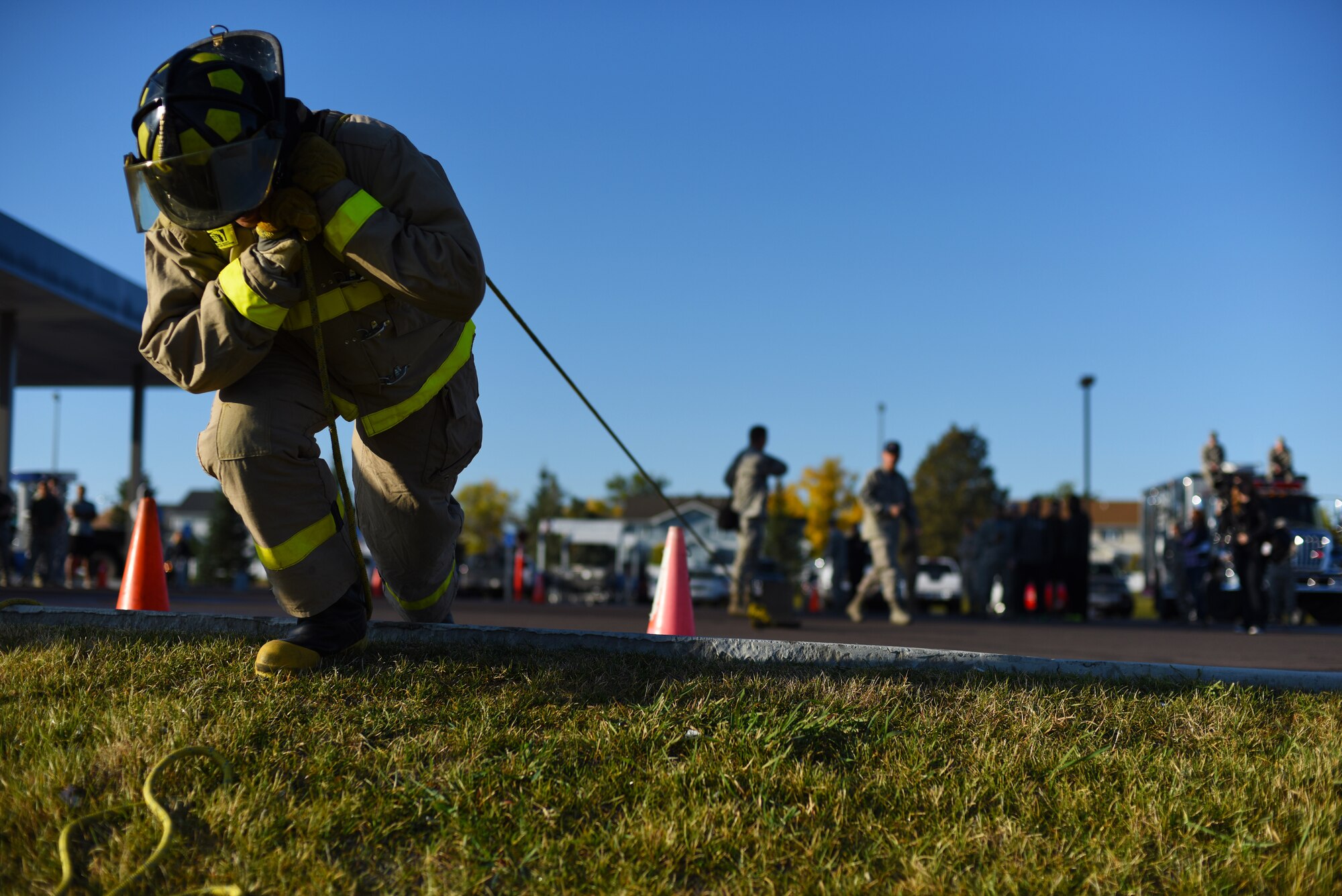 An Airman with the 341st Civil Engineer Squadron pulls a weighted sled during Malmstrom Air Force Base’s fourth annual Fire Prevention Week fire muster Oct. 10. The challenge consisted of about 10 different stations where competitors had to work as a team and muster all their strength to finish with the best time. (U.S. Air Force photo/Airman 1st Class Collin Schmidt) 