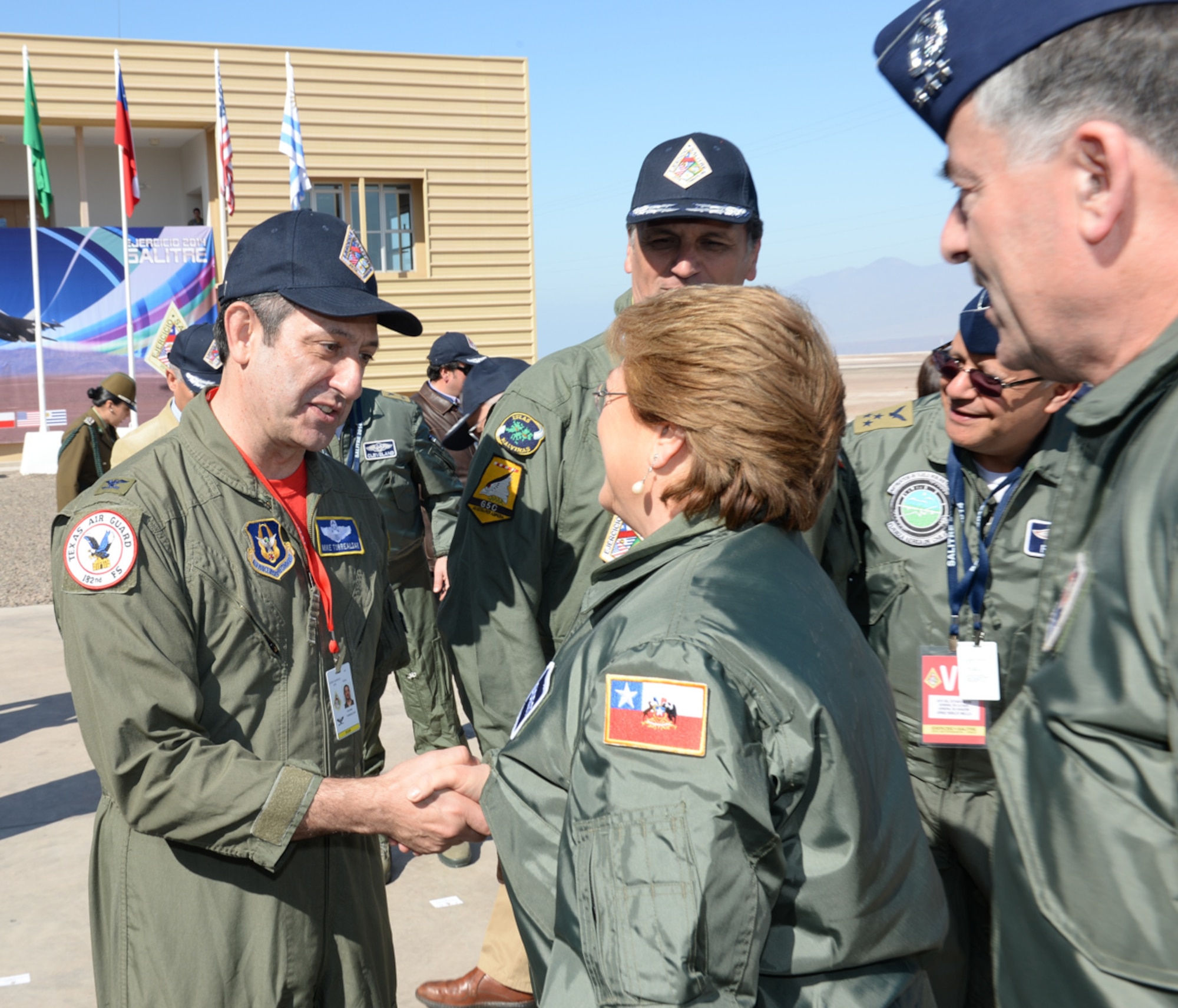 U.S. Air Force Col. Mike Torrealday, Reserve Advisor to the 12th Air Force (Air Forces Southern) Commander, greets President Michelle Bachelet of Chile during her visit to Salitre 2014, Oct. 10. Salitre is a Chilean-led exercise where the U.S., Chile, Brazil, Argentina and Uruguay, focus on increasing interoperability between allied nations. (Air National Guard photo by Senior Master Sgt. Miguel Arellano/released)