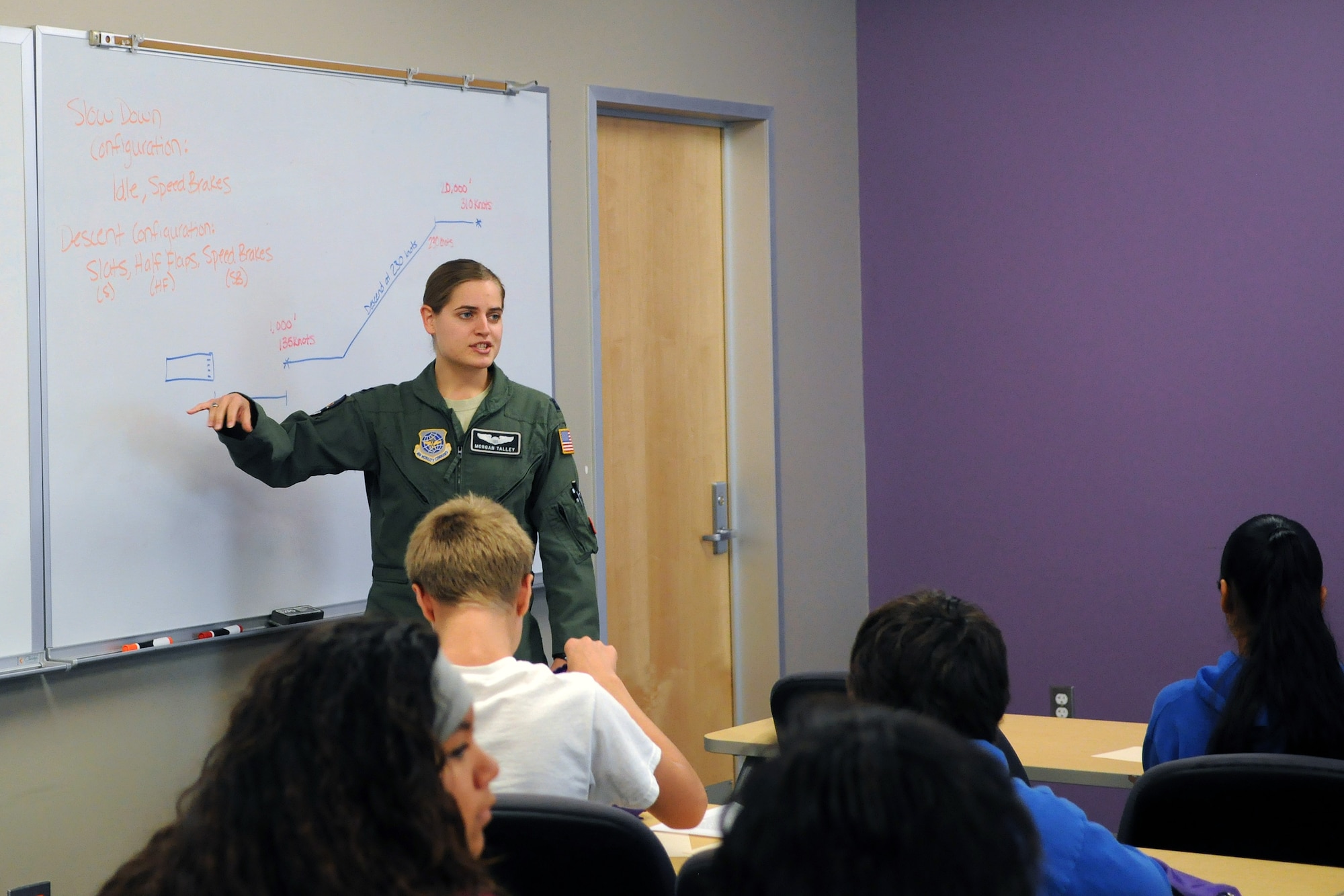 Capt. Morgan Talley, 8th Airlift Squadron pilot, presents 8th-grade students with a math problem Oct. 9, 2014, during the Clover Park Technical College Math Conference in Lakewood, Wash. While at the conference, 8th-grade students from local middle schools learned from Team McChord pilots and loadmasters about the Air Force and how they could further their education as they prepare for high school. (U.S. Air Force photo/Airman 1st Class Jacob Jimenez) 