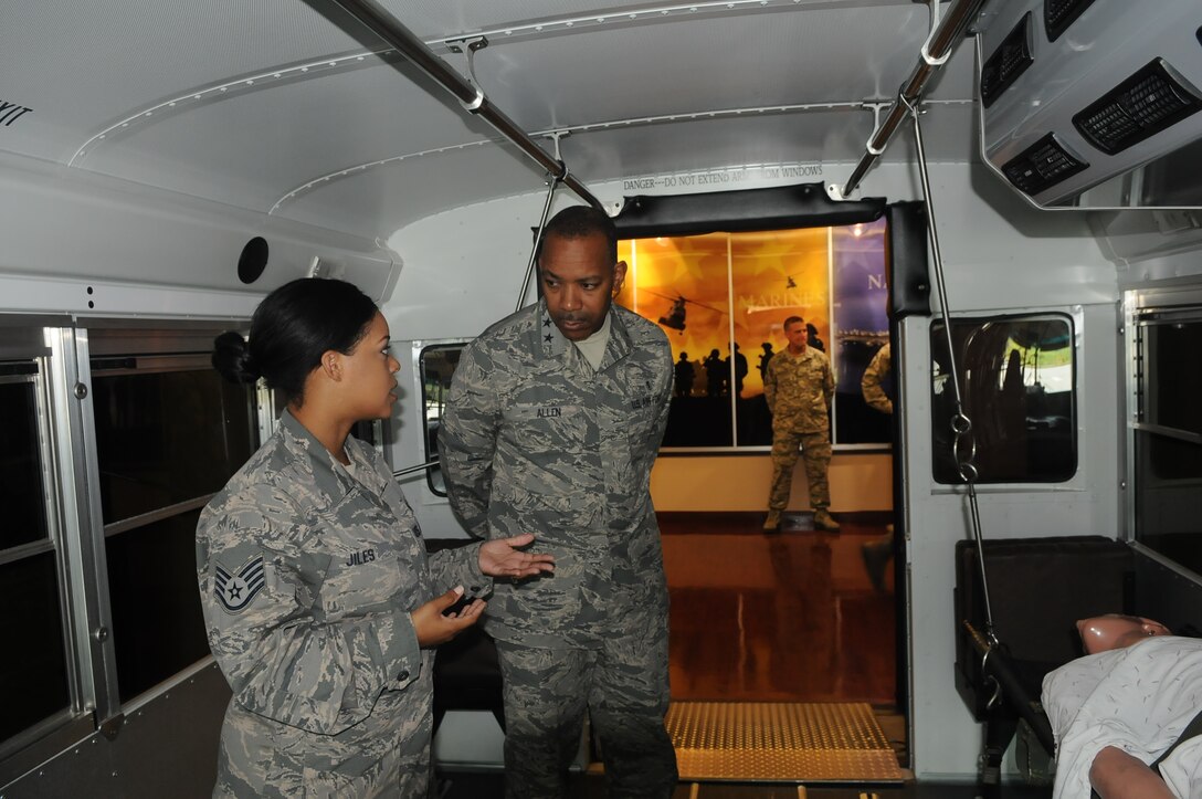 Staff Sgt. Chinita Jiles, Aeromedical Staging Facility (ASF) Medical Technician, explains to Maj. Gen. Roosevelt Allen, 79th Medical Wing Commander,  how the buses are able to move litters during a normal mission.  (AF photo by Captain Tatiana Toquica.)  