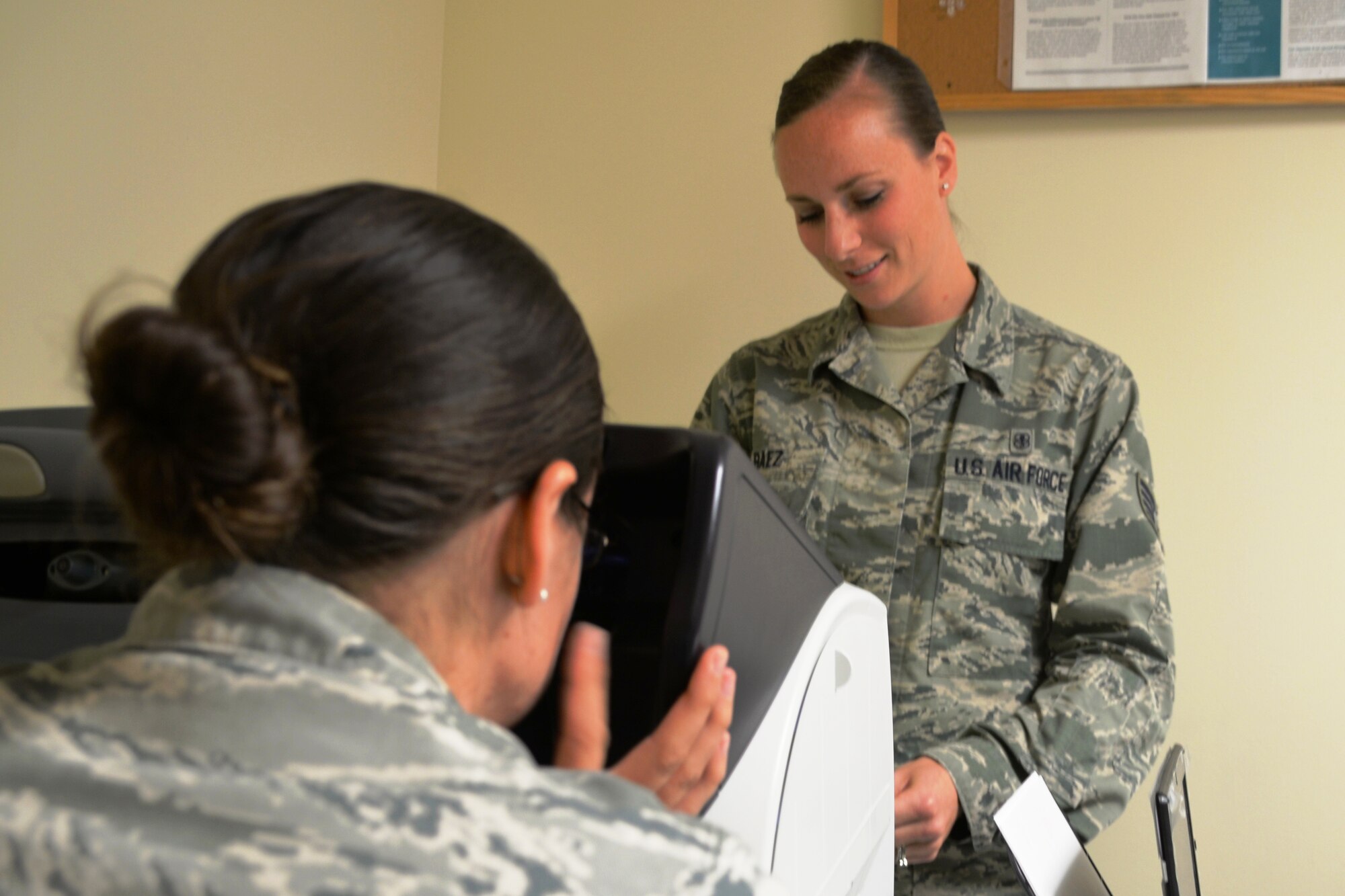 Staff Sgt. Erica Baez, 60th Aerospace Medicine Squadron, conducts a routine depth-perception test as a part of her job as a Flight Medicine technician. Her primary focus is ensuring the Travis flying community is up-to-date on medical qualifications and making sure those standards are being met. (U.S. Air Force photo by Senior Airman Bryan Swink)