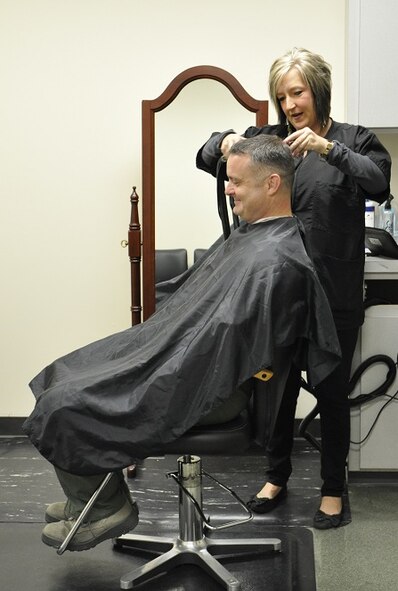 Maj. Adam Groves, 80th Flying Training Wing continuous improvement strategy manager, receives the very first haircut in the newly established barbershop located at the 80th FTW at Sheppard Air Force Base, Texas. The location of the new barbershop will be a convenience for members of the 80th FTW since they will no longer have to travel across base for a haircut. (U.S. Air Force photo/Debi Smith)