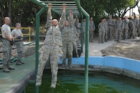 Basic military trainees cross monkey bars over a pool of water as part of the basic military training obstacle course at Joint Base San Antonio-Lackland, Sept. 24, 2014. The mile-and-a-half long course, which permanently closed the same day, was replaced with the Leadership Reaction Course at JBSA-Lackland Medina Annex, which became fully operational Sept. 29. The new course was integrated into the Creating Leaders, Airmen, and Warriors – or CLAW – mission which is part of the basic expeditionary Airmen’s training, also known as BEAST week. (U.S. Air Force photo by Senior Airman Krystal Jeffers/Released)