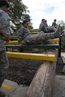 Basic military trainees pull themselves under and over bars as part of the basic military training obstacle course at Joint Base San Antonio-Lackland, Sept. 24, 2014. The obstacle course was about a mile to a mile and a half long depending on what 14 obstacles were open; the two water obstacles would close seasonally. The course, which closed Sept. 24, was replaced by new one, called the Leadership Reaction Course, which was added to basic expeditionary Airmen’s training, also known as BEAST week, at JBSA-Lackland Medina Annex and became fully operational Sept. 29. (U.S. Air Force photo by Senior Airman Krystal Jeffers/Released)