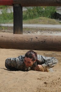 Basic military trainees craw under and over logs part of the basic military training obstacle course at Joint Base San Antonio-Lackland, Sept. 24, 2014. The trainees completed the last run of course before its permanent closure the same day. A new course, called the Leadership Reaction Course, was added to basic expeditionary Airmen’s training, also known as BEAST week, at JBSA-Lackland Medina Annex and became fully operational Sept. 29.  (U.S. Air Force photo by Senior Airman Krystal Jeffers/Released)