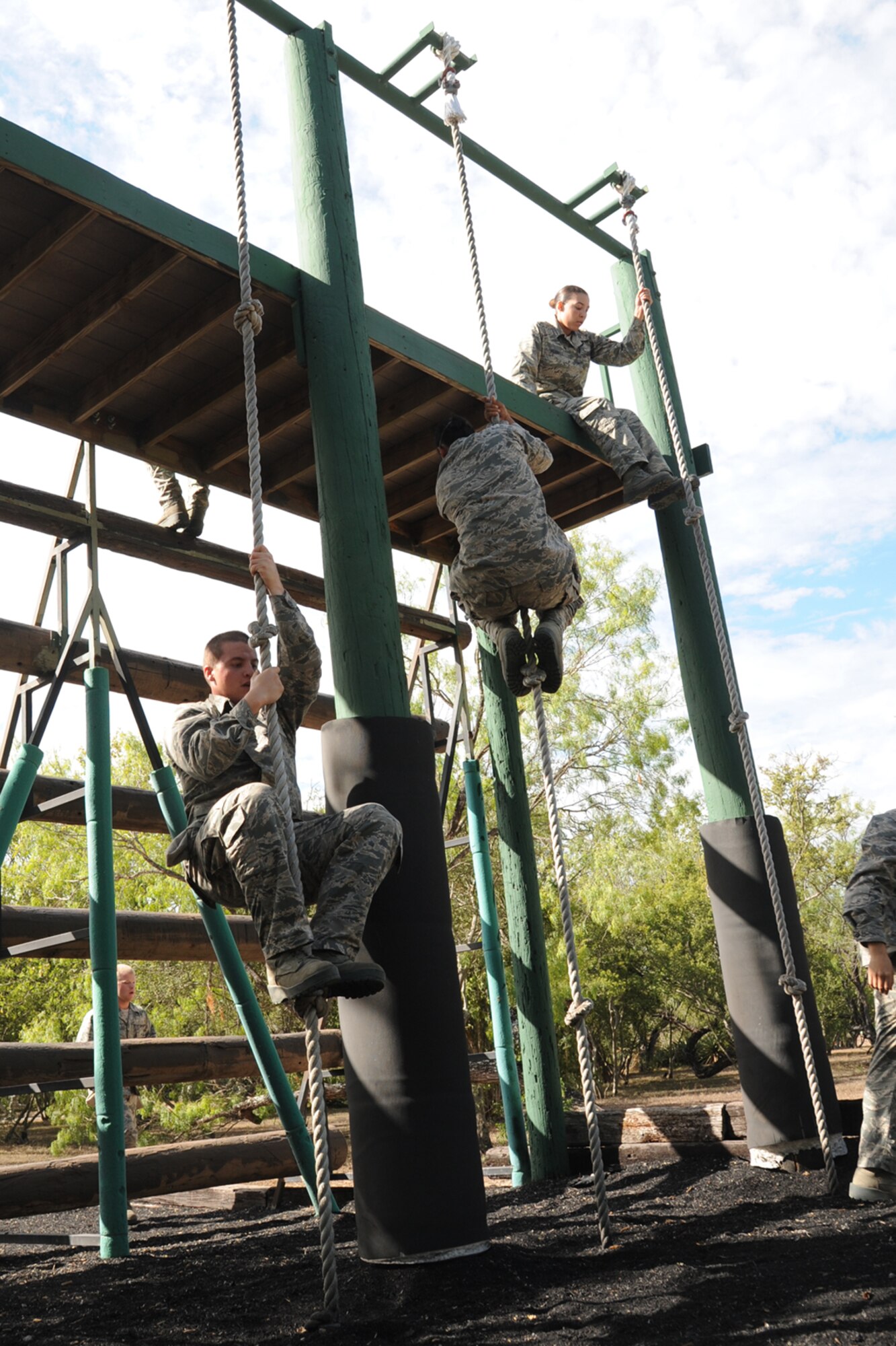 Basic military trainees slide down 14 feet with a rope as part of the basic military training obstacle course Sept. 24, 2014 at Joint Base San Antonio-Lackland. The trainees completed the last run of mile-and-a-half long course before its permanent closure the same day.  A new course, called the Leadership Reaction Course, was integrated into the Creating Leaders, Airmen, and Warriors mission. The CLAW is part of the basic expeditionary Airmen’s training, also known as BEAST week, at JBSA-Lackland Medina Annex and became fully operational Sept. 29. (U.S. Air Force photo by Senior Airman Krystal Jeffers/Released)