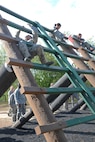 Basic military trainees climb up an obstacle before climbing down the other side Sept. 24, 2014at Joint Base San Antonio-Lackland’s basic military training obstacle course.. The course, which closed permanently the same day, was replaced with the ‘Leadership Reaction Course’ at JBSA-Lackland Medina Annex. The new course became operational Sept. 29, 2014 and was integrated into the Creating Leaders, Airmen, and Warriors mission which is part of the basic expeditionary Airmen’s training, also known as BEAST week during BMT. (U.S. Air Force photo by Senior Airman Krystal Jeffers/Released)